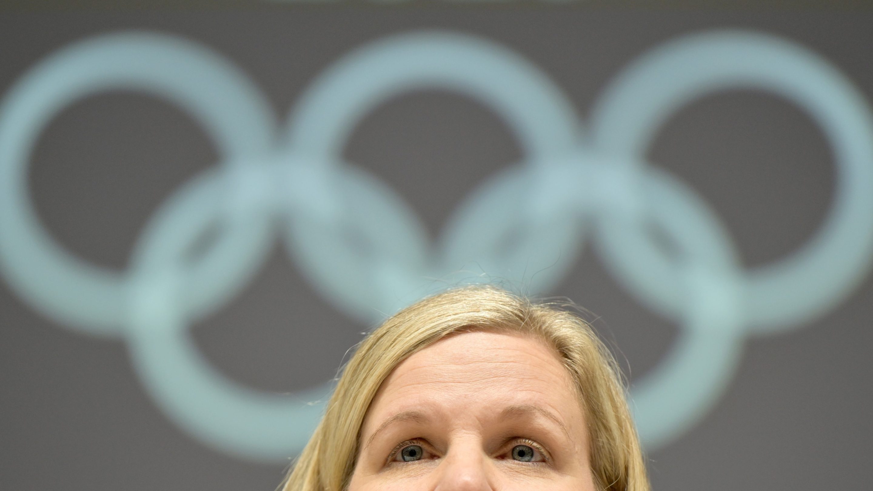 Kirsty Coventry, President of the International Olympic Committee (IOC) speaks to media representatives before the conclusion of the Olympic Winter Games Milan Cortina 2026. The photo shows her eyes and forehead below the Olympic rings.