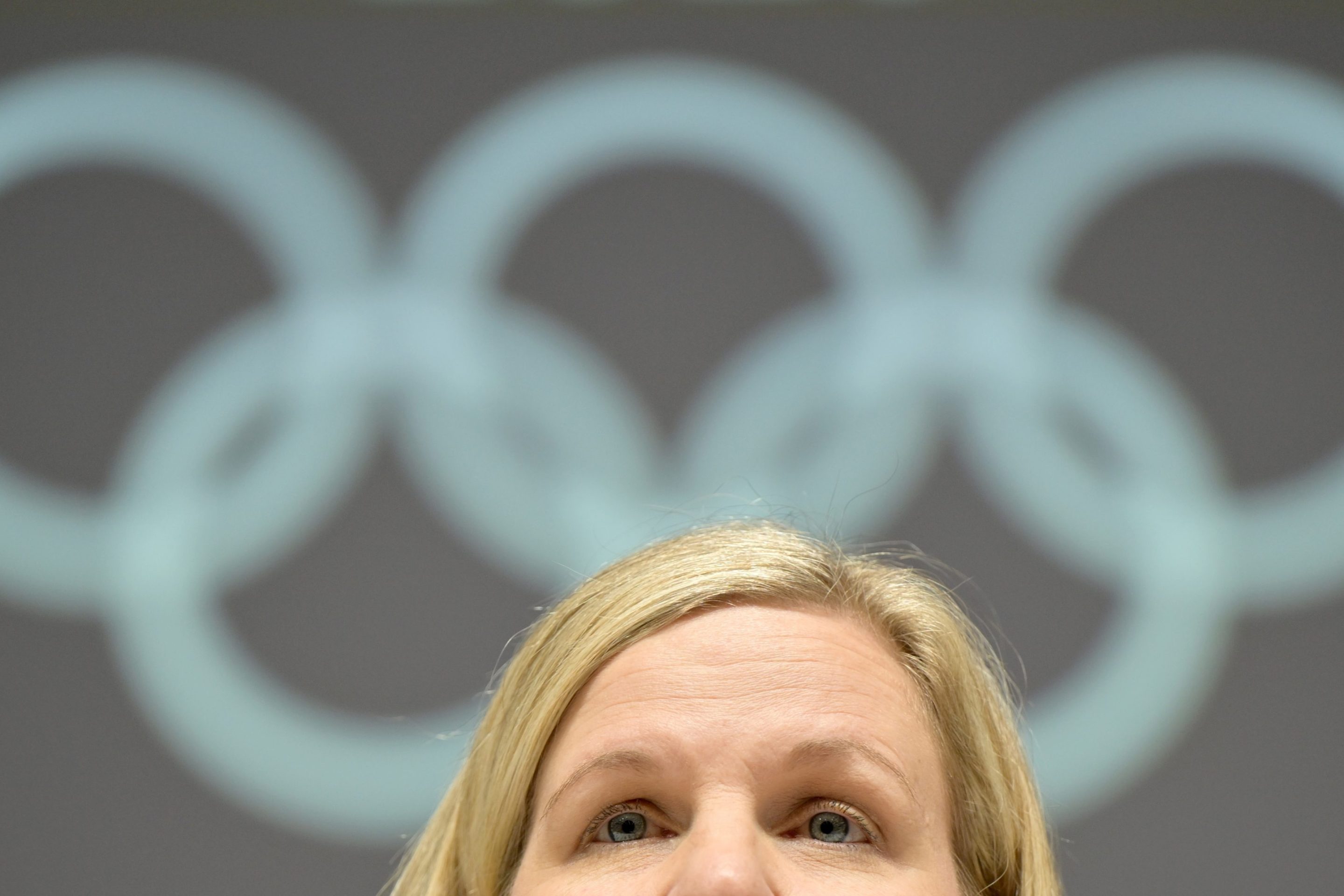 Kirsty Coventry, President of the International Olympic Committee (IOC) speaks to media representatives before the conclusion of the Olympic Winter Games Milan Cortina 2026. The photo shows her eyes and forehead below the Olympic rings.