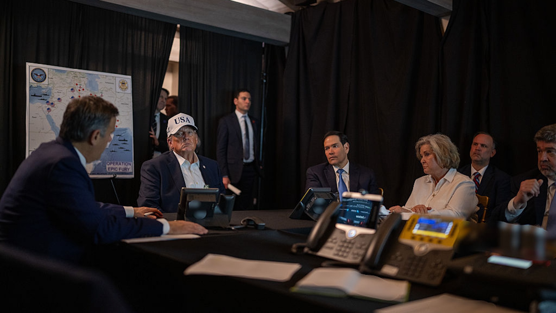 Donald Trump wearing his stupid hat in the situation room at Mar-a-Lago