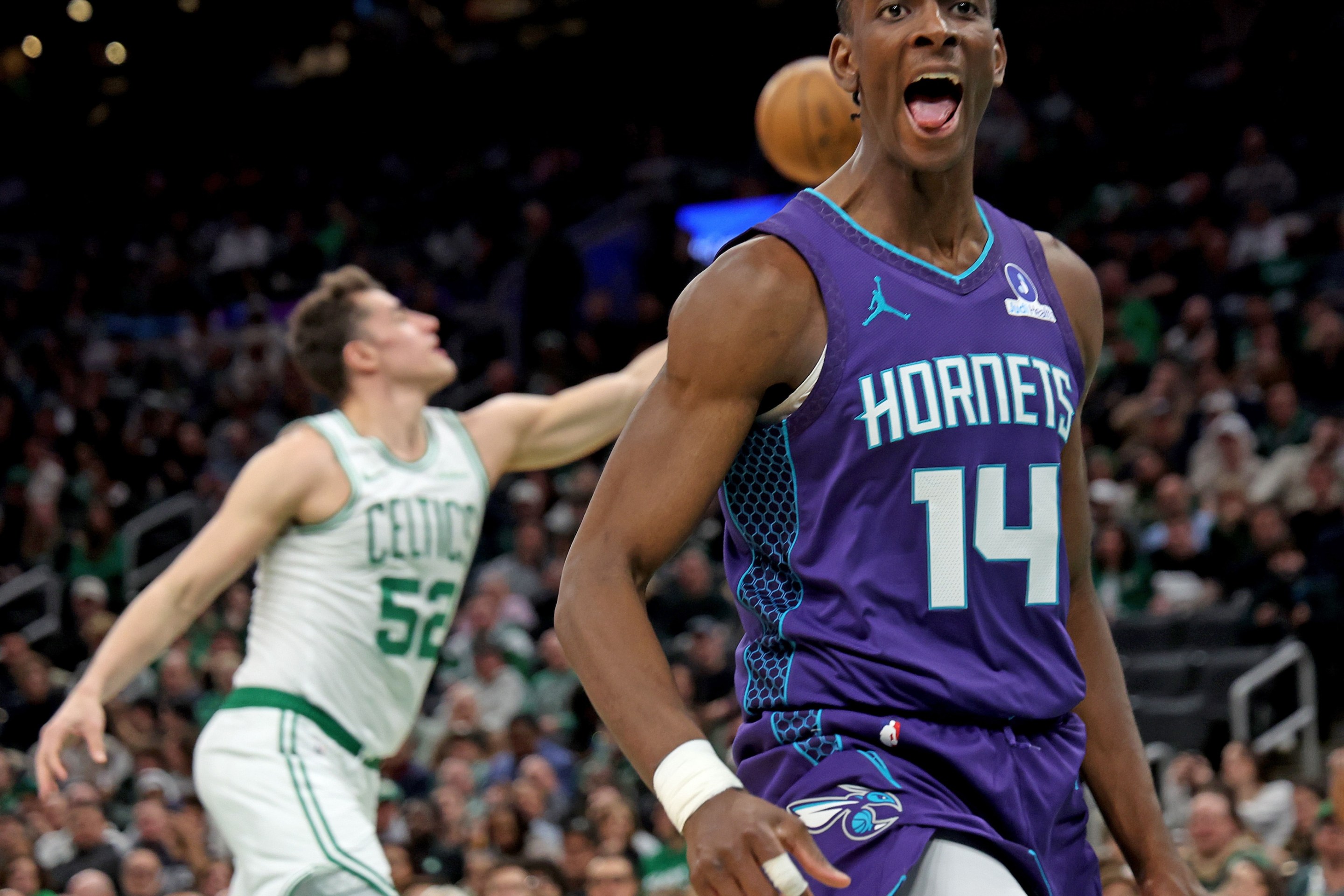 Charlotte Hornets forward Moussa Diabate (14) screams out after dunking during the first half of a NBA game at the TD Garden.