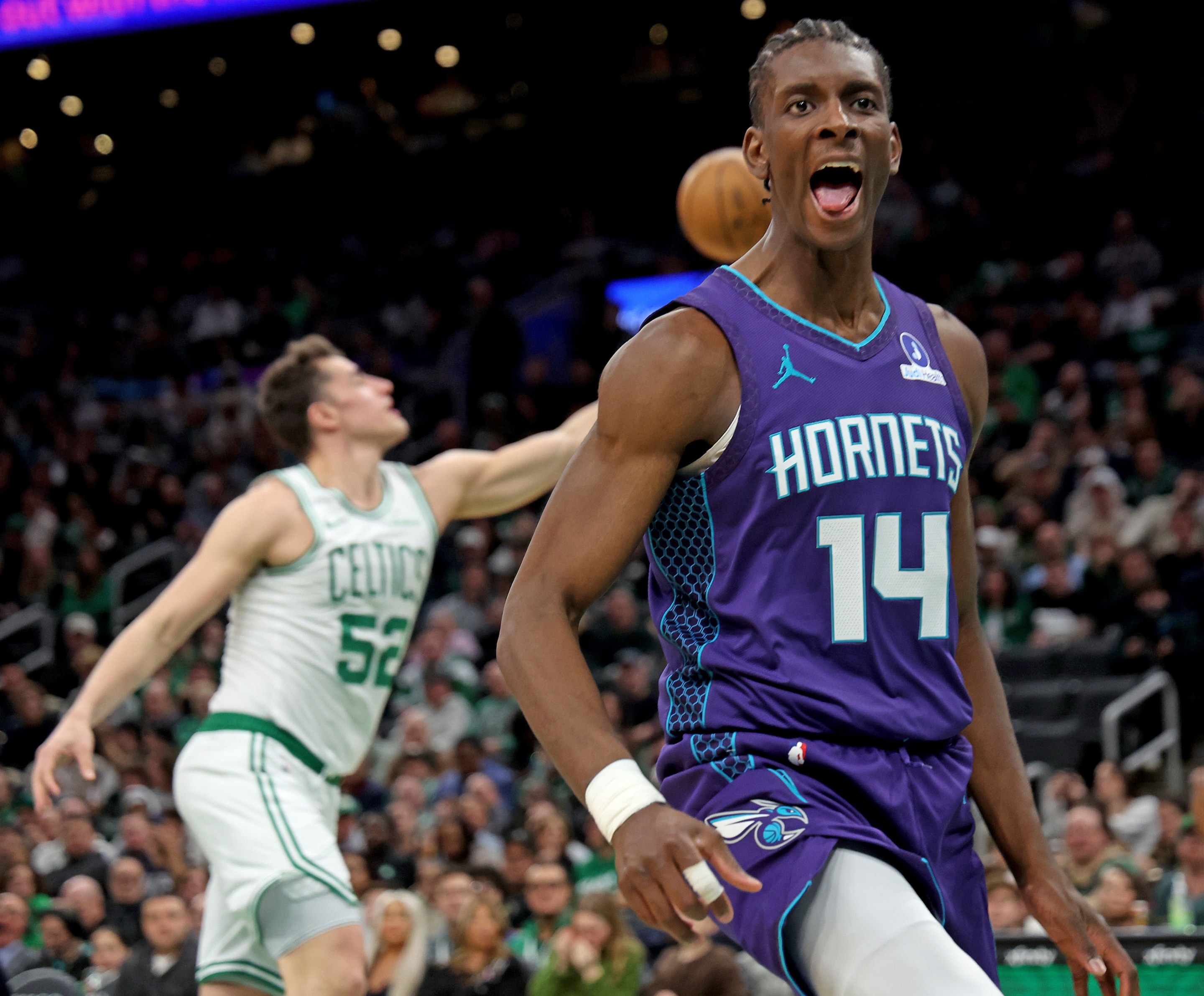 Charlotte Hornets forward Moussa Diabate (14) screams out after dunking during the first half of a NBA game at the TD Garden.