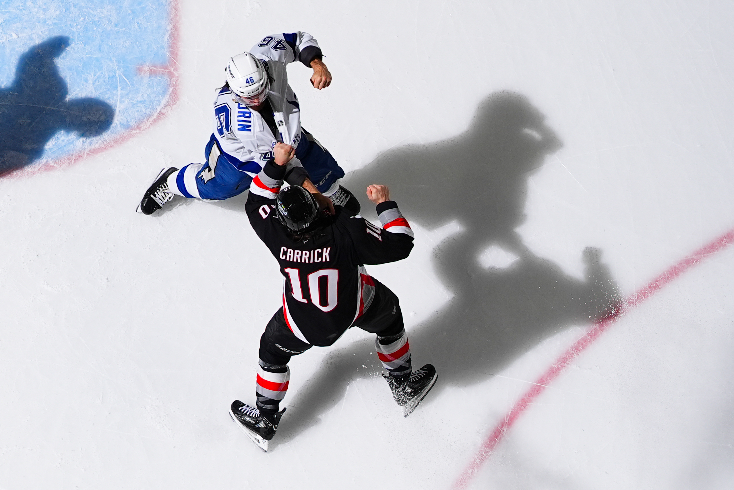 Scott Sabourin of the Tampa Bay Lightning fights Sam Carrick of the Buffalo Sabres on March 8, 2026. The shadows look cool.