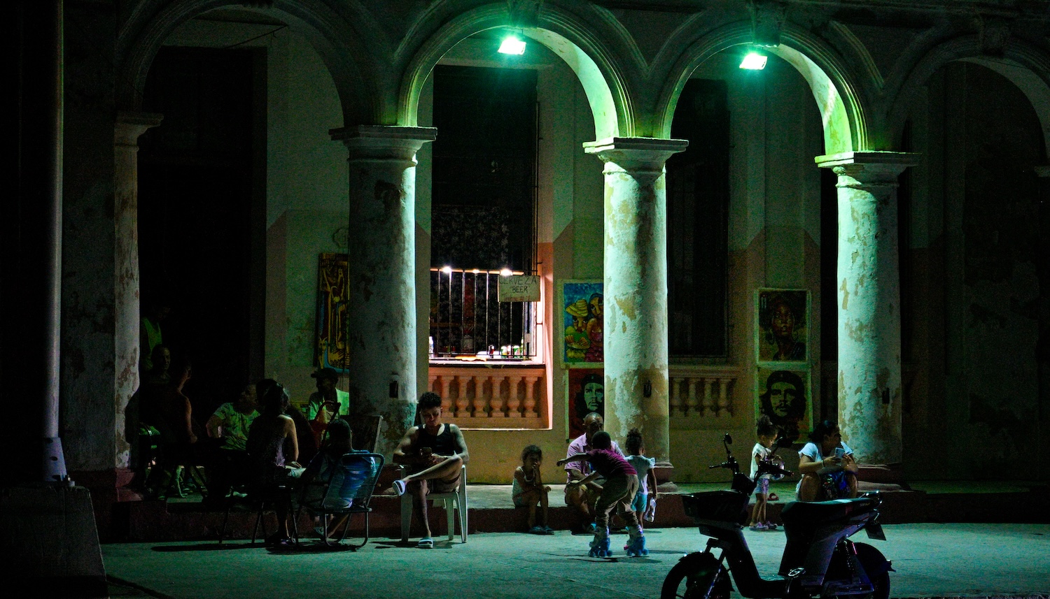 Cubans gather in front of their houses during a blackout in Havana on March 16, 2026. Cuba suffered a widespread power cut on March 16, 2026, according to the national electricity company, against the backdrop of a severe crisis on the island caused by the US energy blockade. (Photo by ADALBERTO ROQUE / AFP)