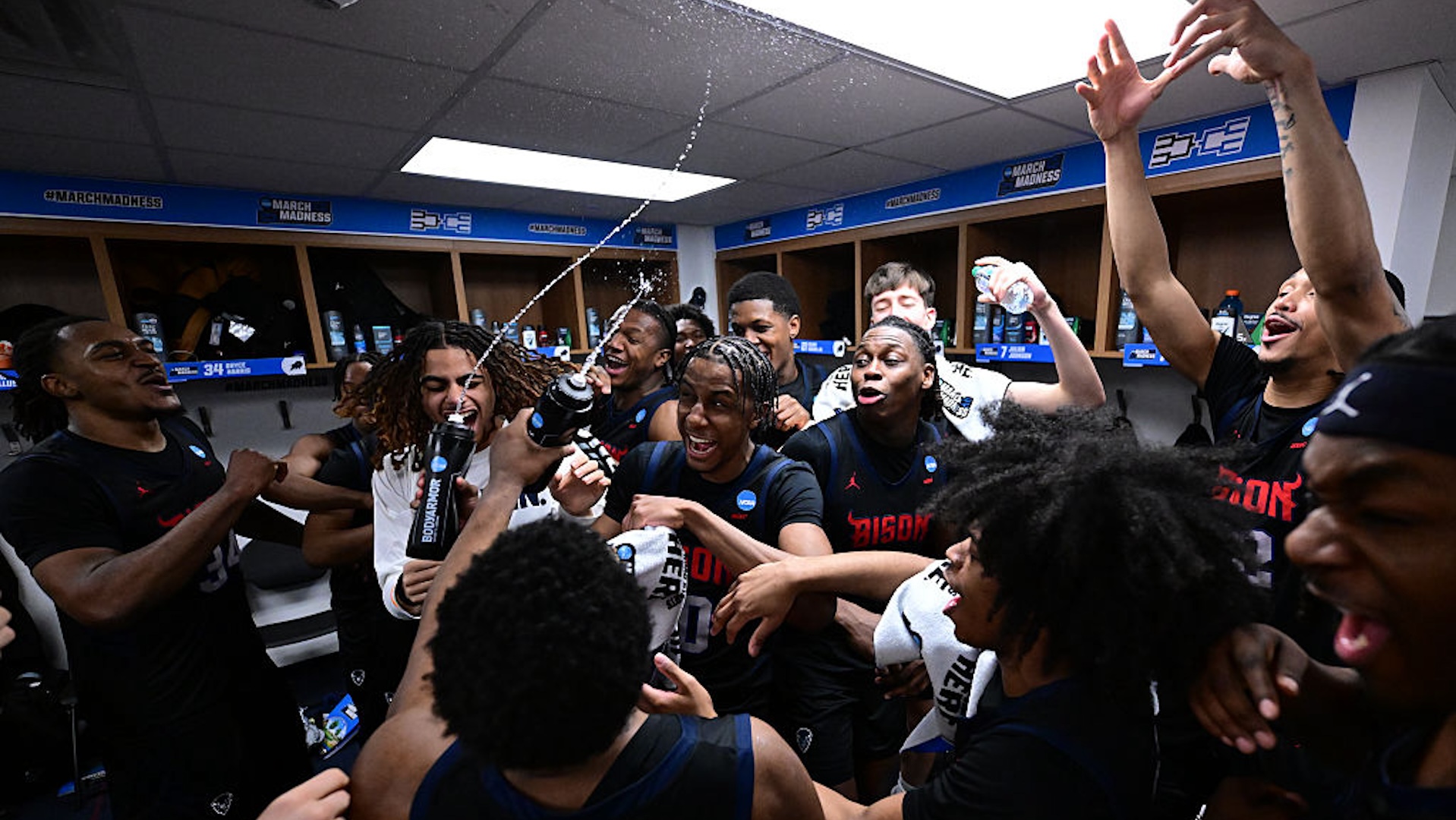 Howard players celebrate their victory in the locker room