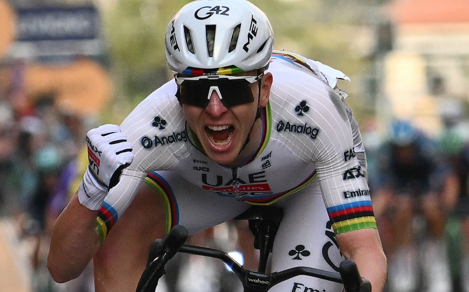 UAE Team Emirate's Slovenian rider Tadej Pogacar celebrates as he crosses the finish line to win the 117th Milan - Sanremo one-day classic cycling race, in Sanremo on March 21, 2026.