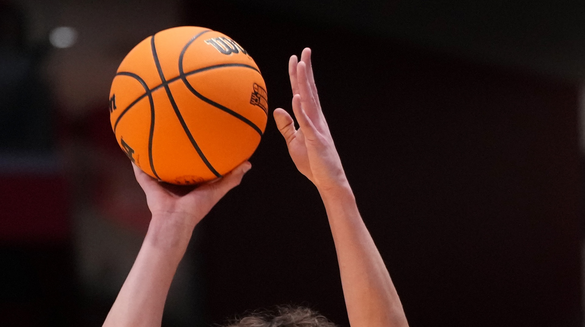 A tightly cropped image of a player releasing a jump shot