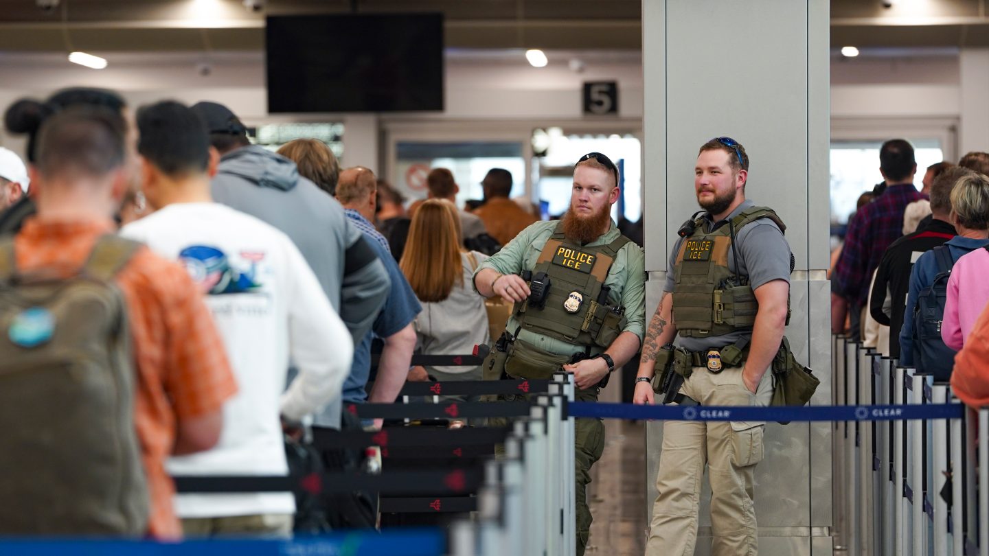 ATLANTA, GEORGIA - MARCH 23: ICE agents stand next to the security line at Atlanta Hartsfield-Jackson International Airport on March 23, 2026 in Atlanta, Georgia.The travel disruptions continue as hundreds of TSA agents quit or work without pay during a partial government shutdown. U.S. President Donald Trump said ICE agents will be deployed to U.S. airports on Monday, with border czar Tom Homan in charge of the effort.(Photo by Megan Varner/Getty Images)