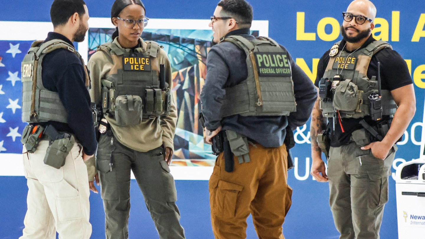 Federal law enforcement agents, including some with US Immigration and Customs Enforcement (ICE), stand inside Newark Liberty International Airport in Newark, New Jersey, on March 23, 2026. Immigration agents will be deployed in US airports beginning Monday, aiming to alleviate soaring congestion at security screenings amid a weeks-long budget standoff over President Donald Trump's mass deportation drive, officials said. (Photo by kena betancur / AFP via Getty Images)