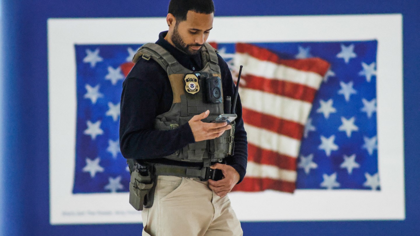 A US Immigrations and Customs Enforcement (ICE) stands watch inside Newark Liberty International Airport in Newark, New Jersey, on March 23, 2026. Immigration agents will be deployed in US airports beginning Monday, aiming to alleviate soaring congestion at security screenings amid a weeks-long budget standoff over President Donald Trump's mass deportation drive, officials said. (Photo by kena betancur / AFP via Getty Images)