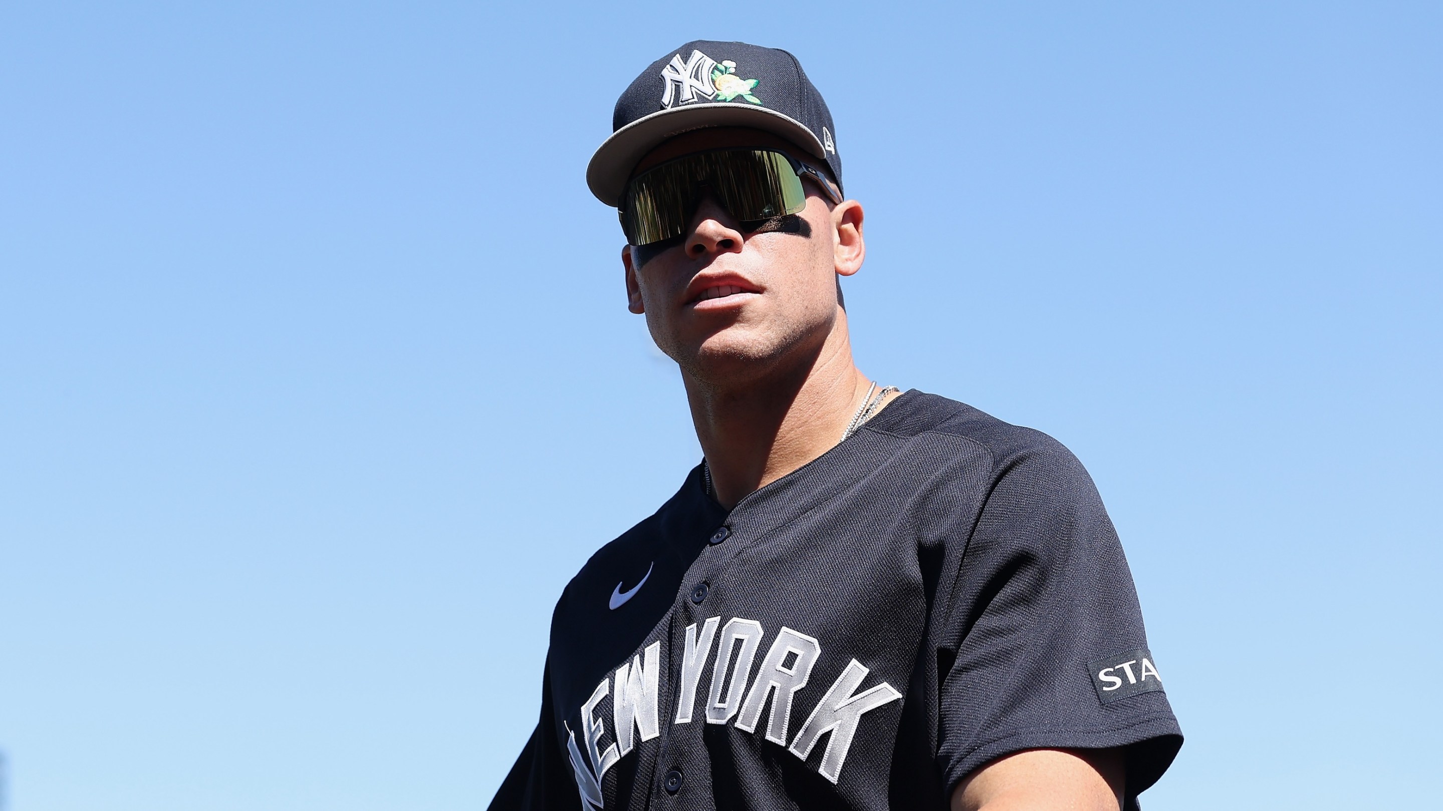 Aaron Judge of the New York Yankees arrives to the spring training game against the Chicago Cubs on March 23, 2026 in Mesa, Arizona. He's got big goofy shades on.