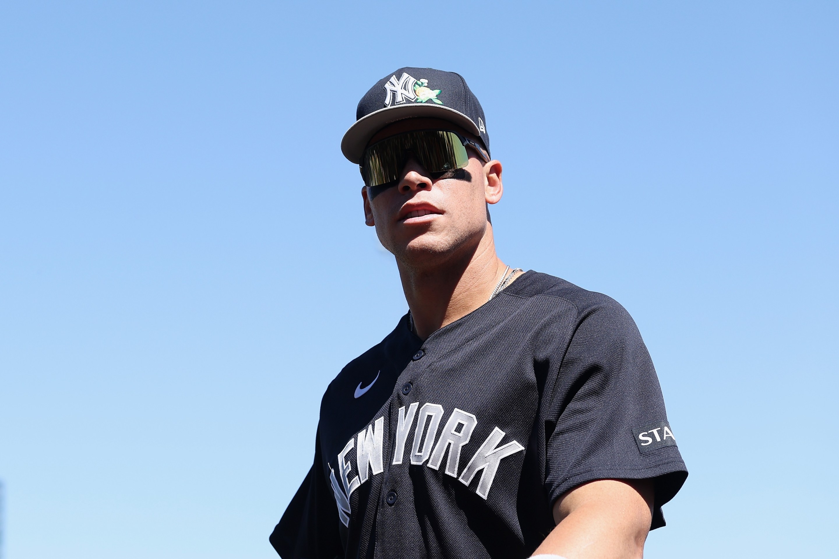 Aaron Judge of the New York Yankees arrives to the spring training game against the Chicago Cubs on March 23, 2026 in Mesa, Arizona. He's got big goofy shades on.
