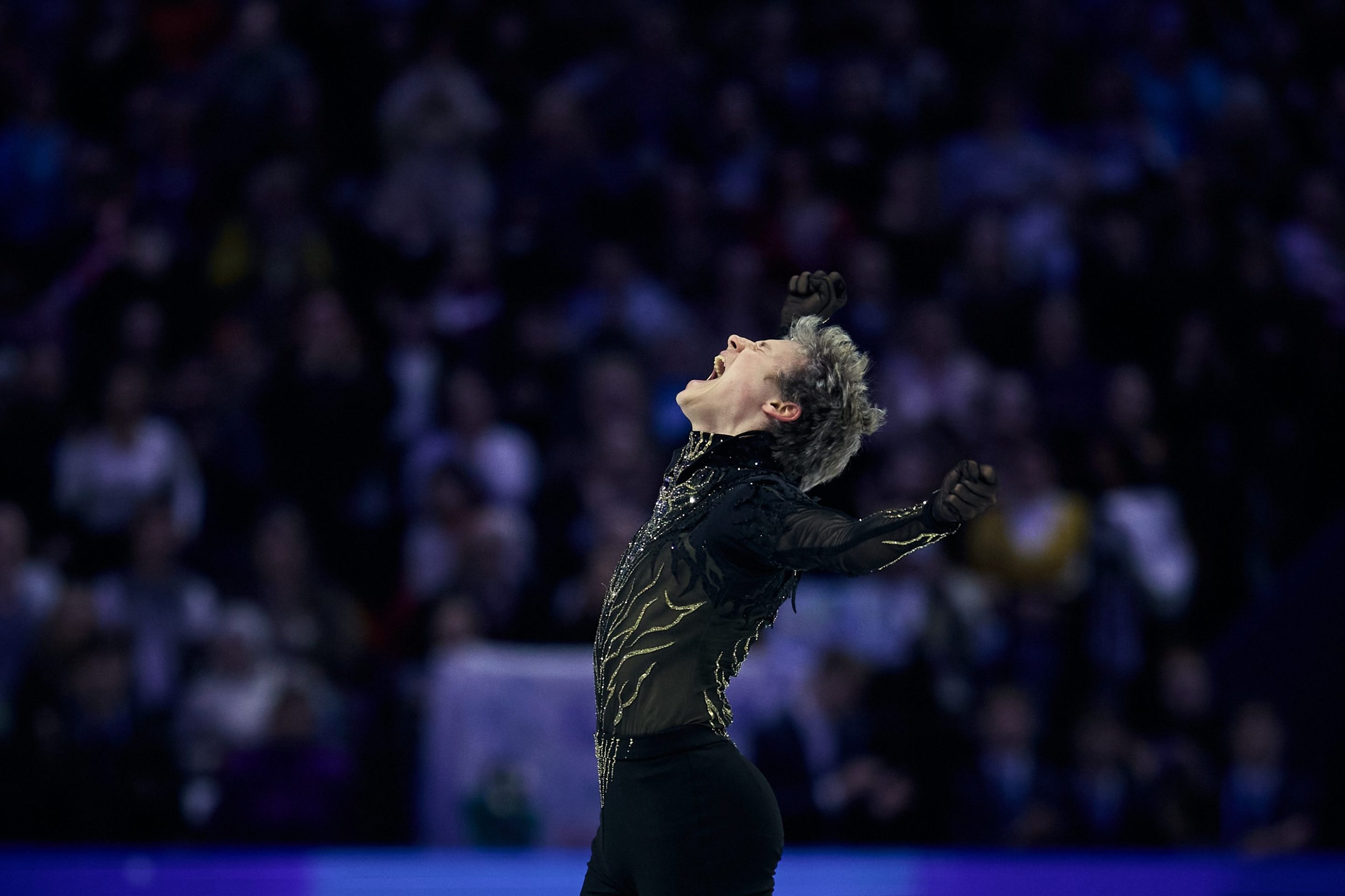Ilia Malinin of United States reacts in the Men's Free Skating during the ISU World Figure Skating Championships at O2 Arena on March 28, 2026 in Prague, Czech Republic. His head is thrown back in joy, with his arms up in the air.
