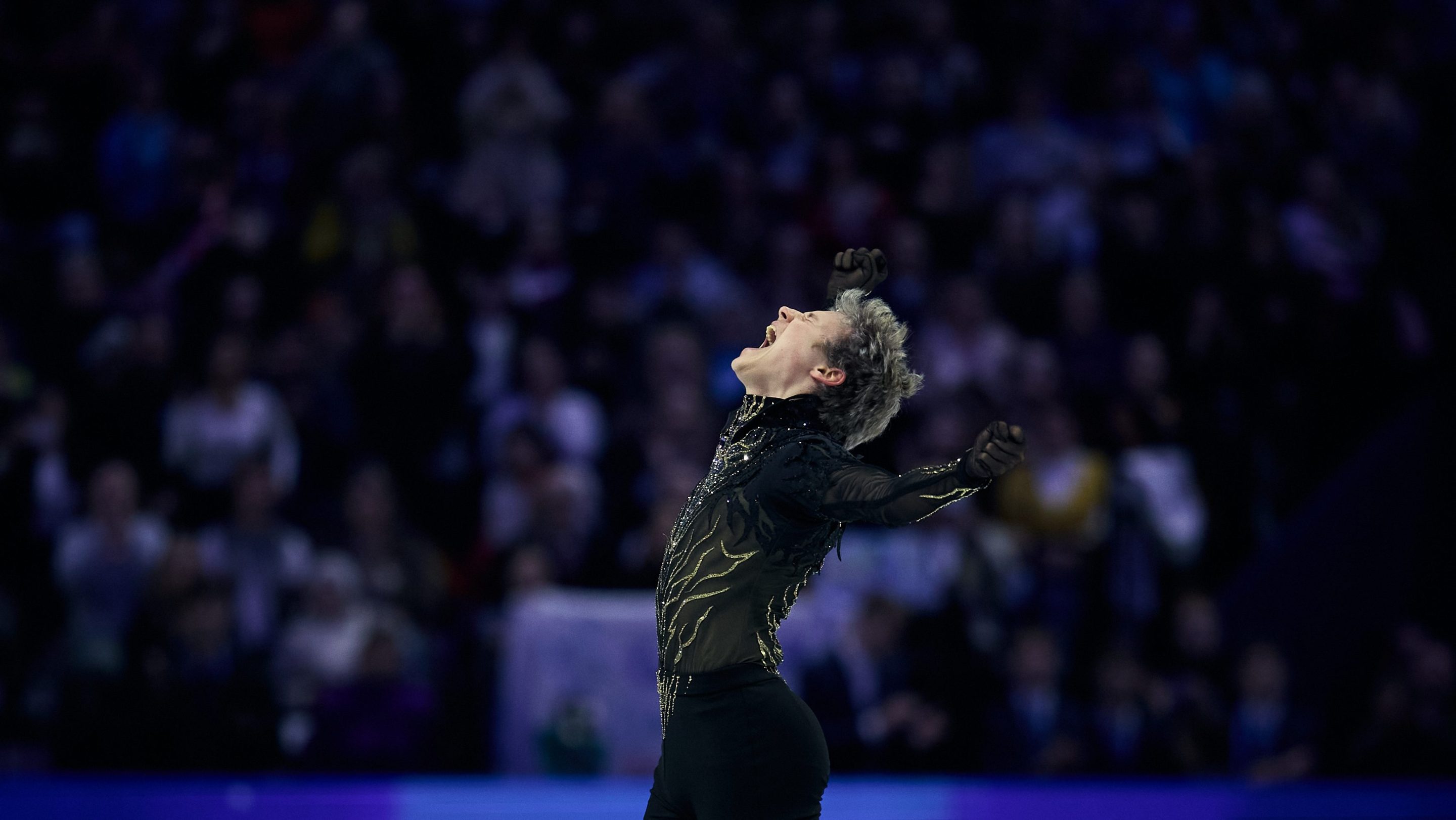 Ilia Malinin of United States reacts in the Men's Free Skating during the ISU World Figure Skating Championships at O2 Arena on March 28, 2026 in Prague, Czech Republic. His head is thrown back in joy, with his arms up in the air.