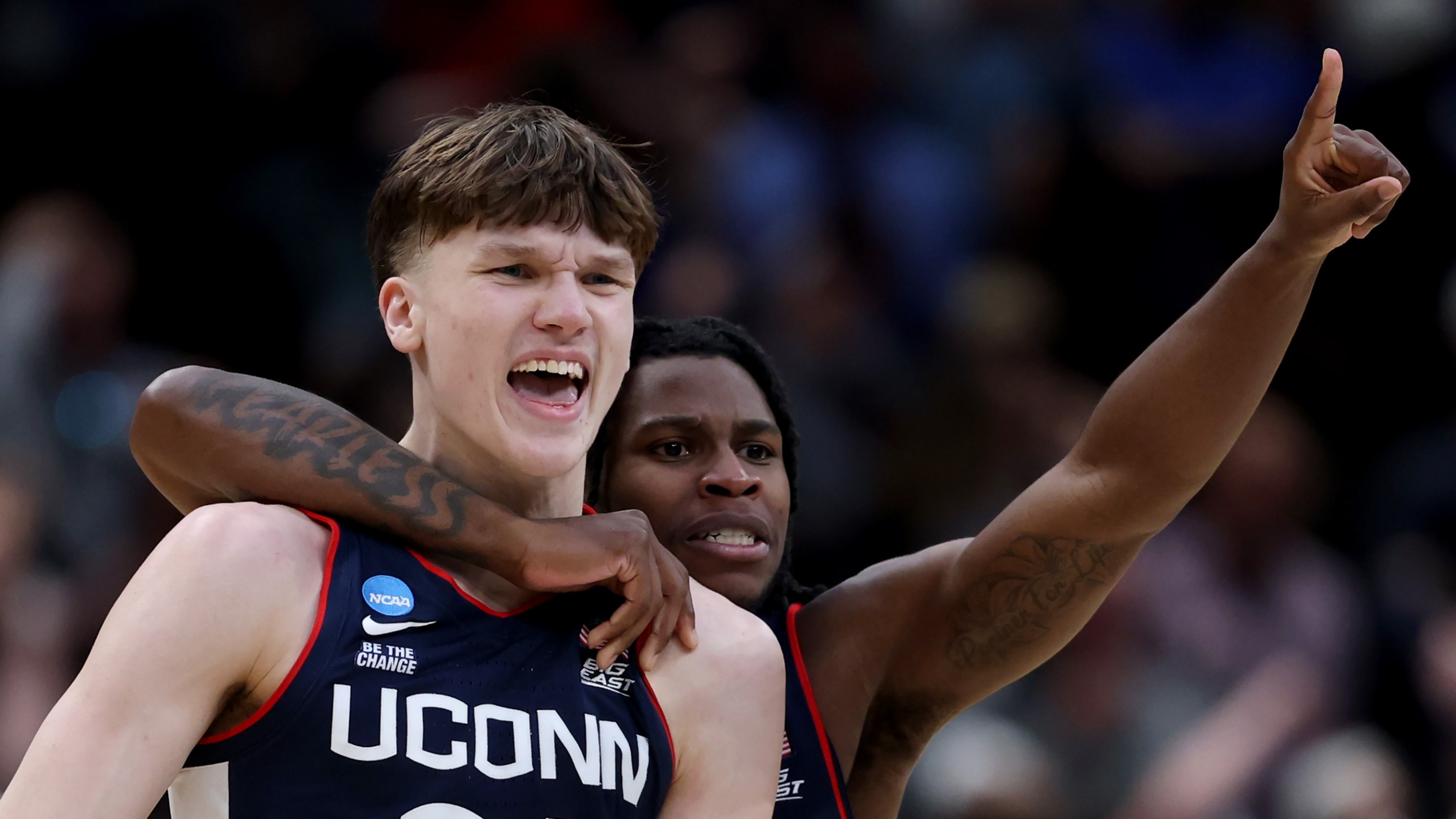 Braylon Mullins #24 celebrates with Malachi Smith #0 of the UConn Huskies after shooting the game-winning three point basket