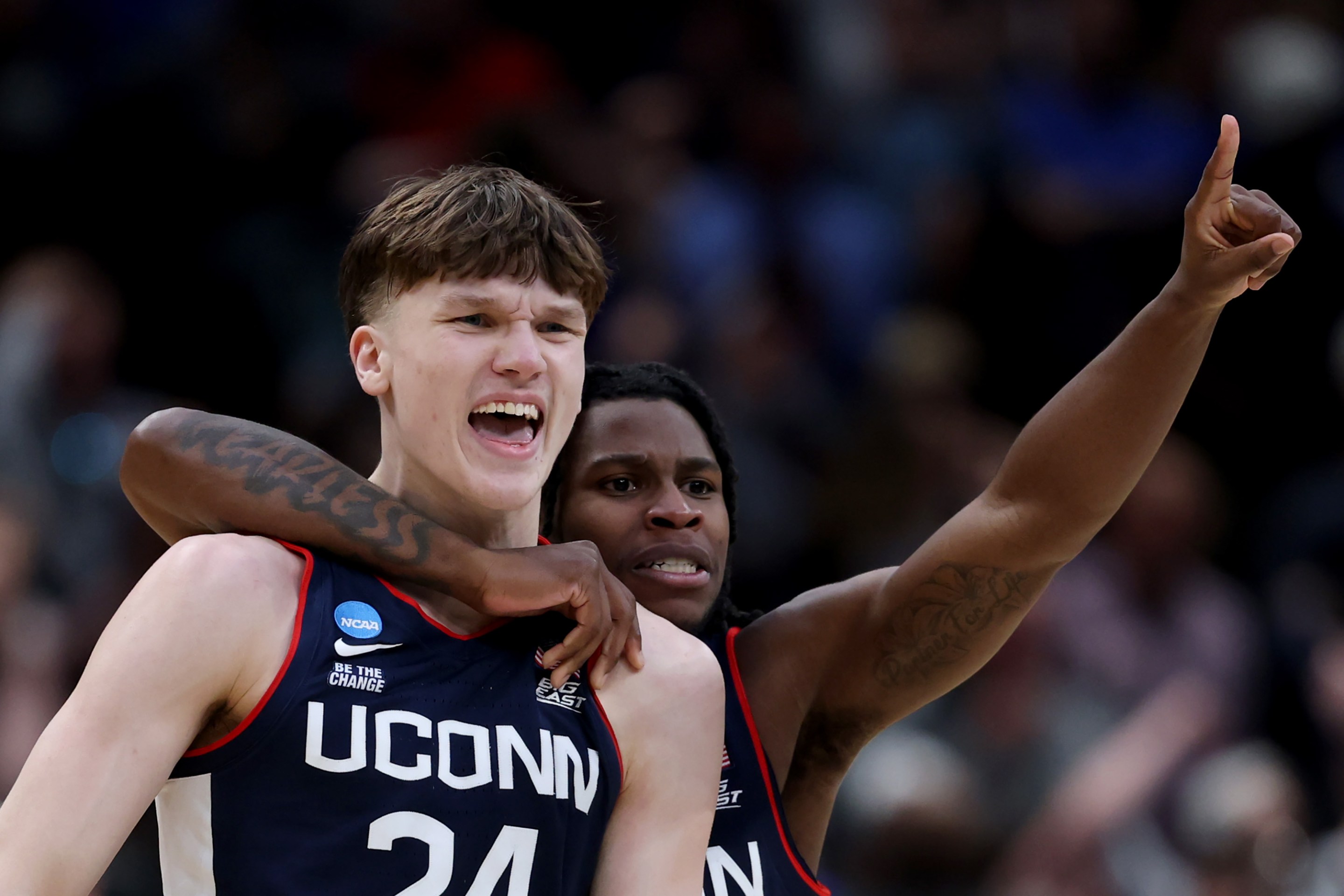 Braylon Mullins #24 celebrates with Malachi Smith #0 of the UConn Huskies after shooting the game-winning three point basket
