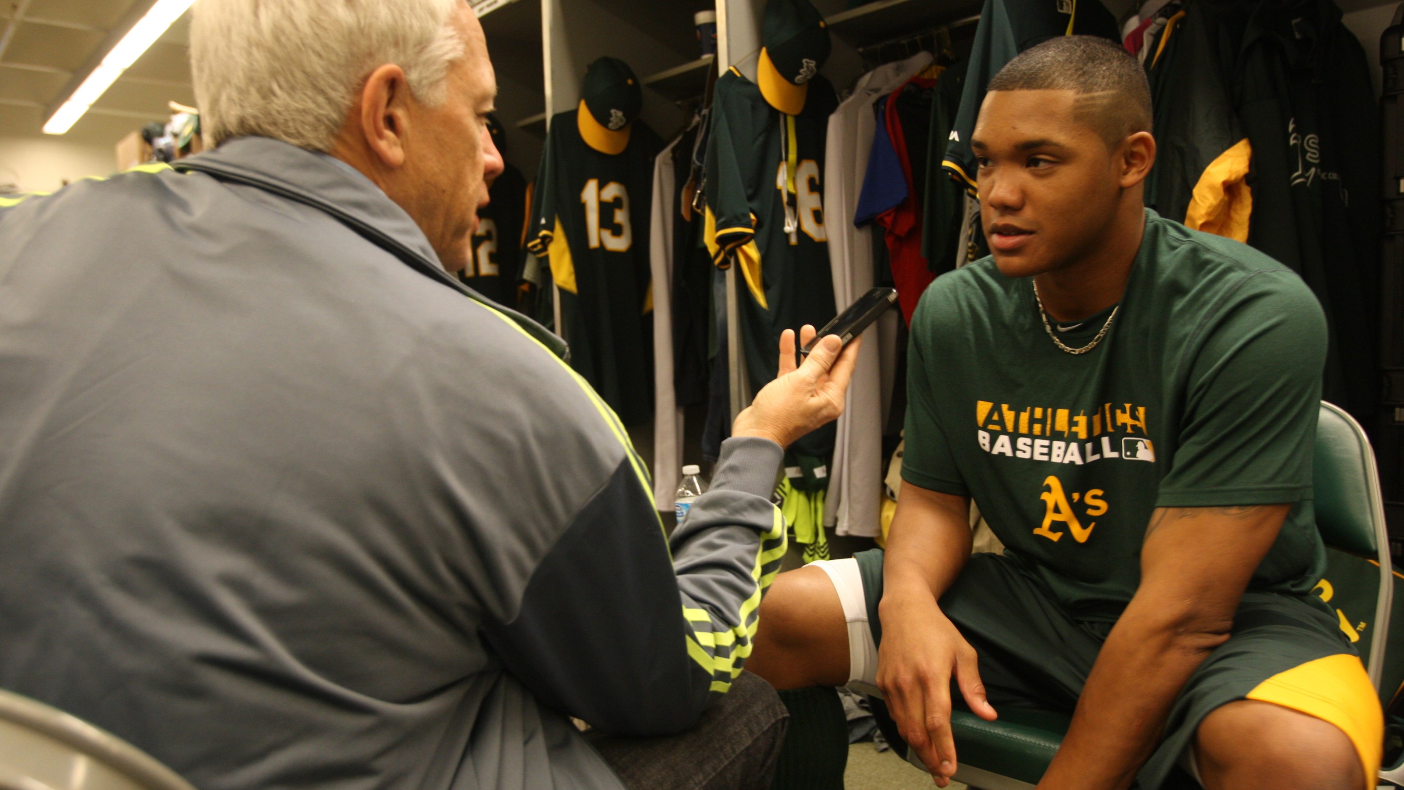 Scott Ostler of the San Francisco Chronicle interviews an A's player, who is sadly Addison Russell, during Spring Training in 2014.