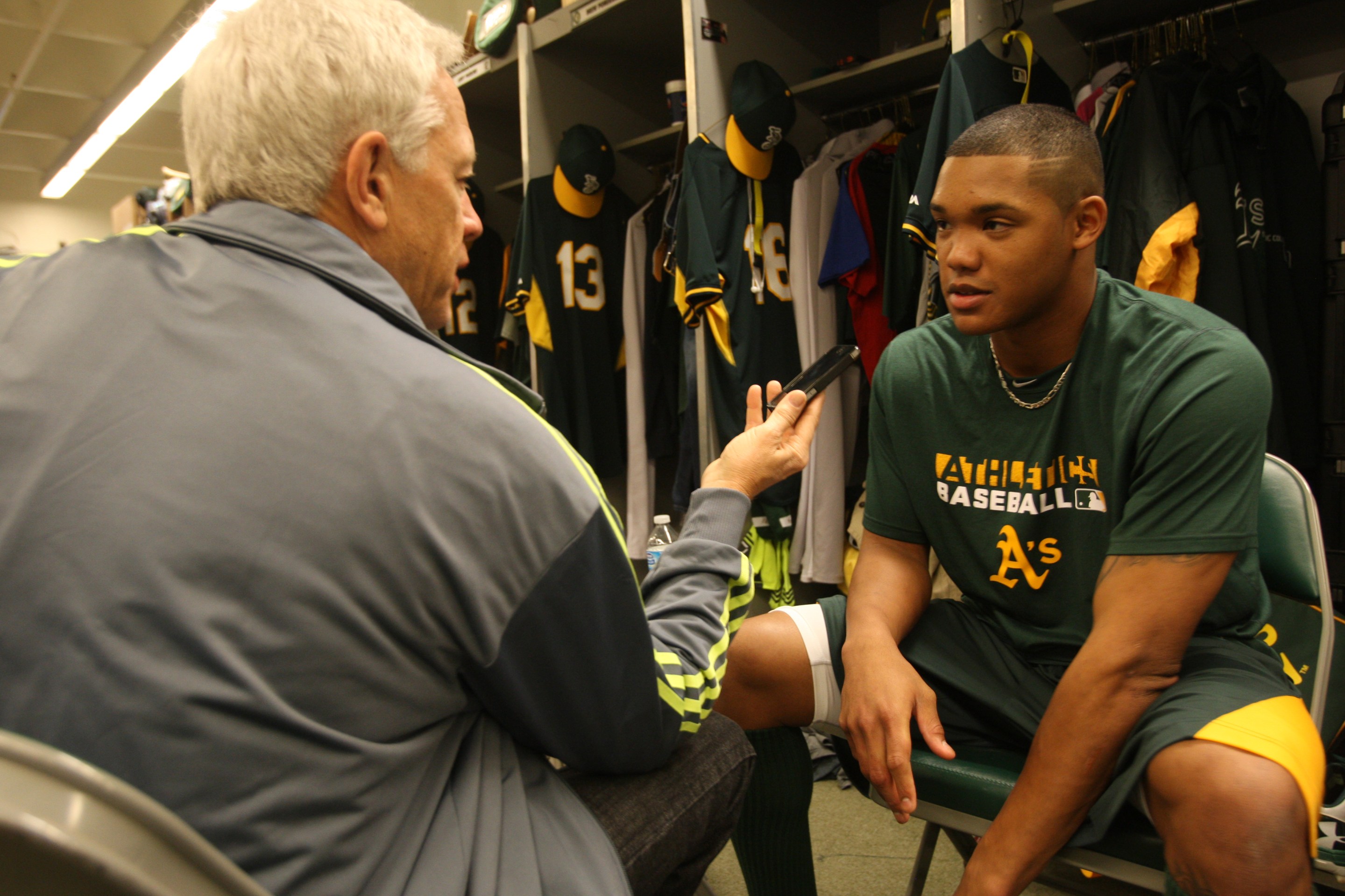 Scott Ostler of the San Francisco Chronicle interviews an A's player, who is sadly Addison Russell, during Spring Training in 2014.
