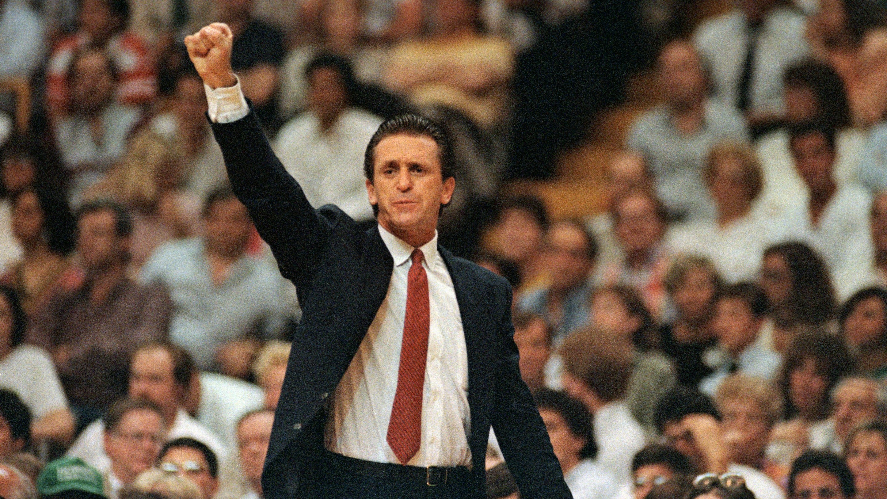 Los Angeles Lakers coach Pat Riley raises his fist as the Lakers take the lead and go on to win game 4 in the final seconds to defeat Boston, 107-106. Photo is from June of 1987 and Riley's suit is immaculate.