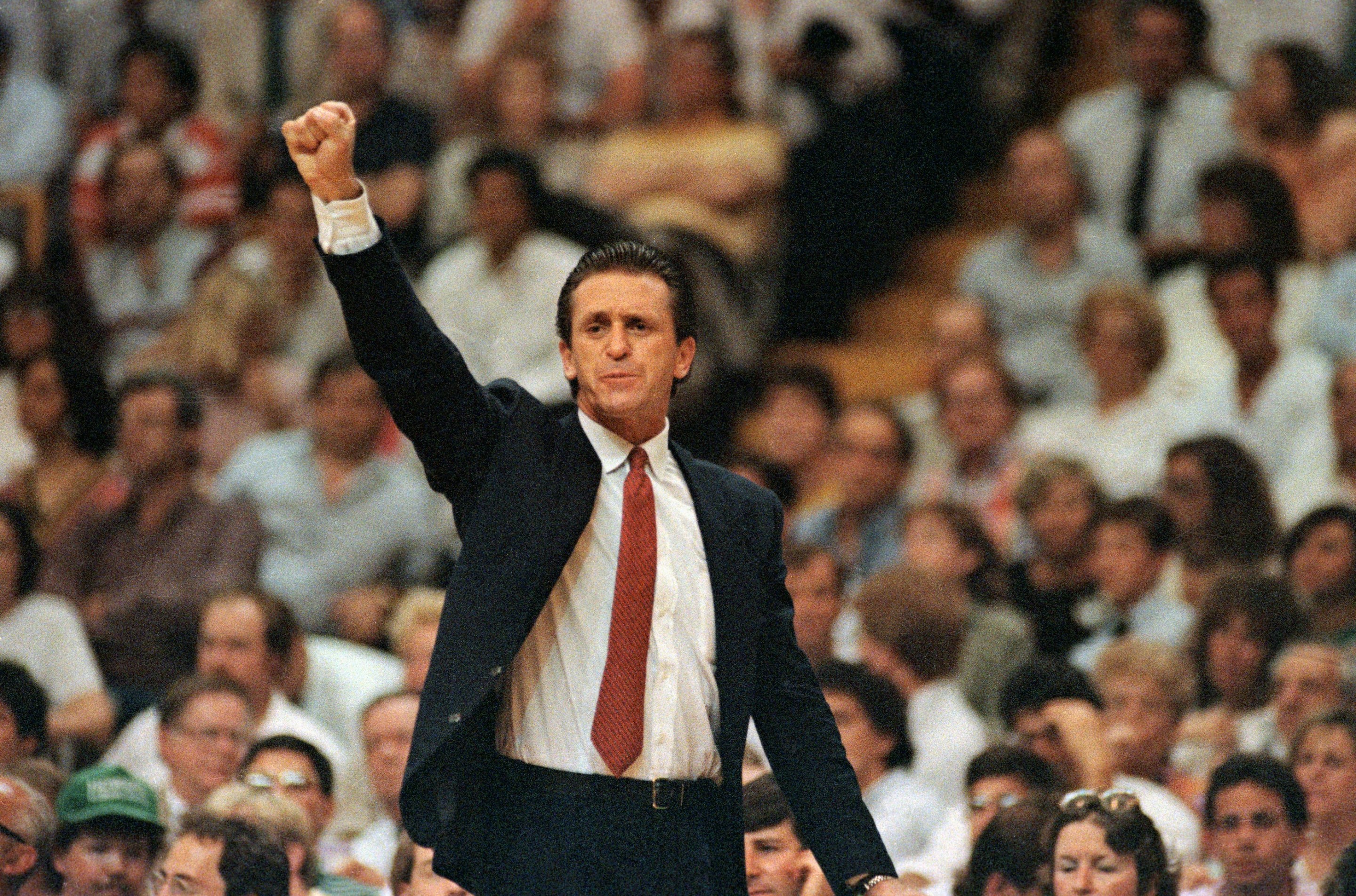 Los Angeles Lakers coach Pat Riley raises his fist as the Lakers take the lead and go on to win game 4 in the final seconds to defeat Boston, 107-106. Photo is from June of 1987 and Riley's suit is immaculate.