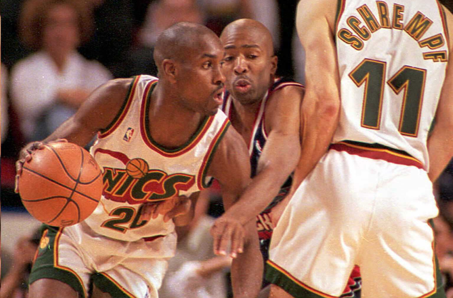 Houston Rockets Kenny Smith (C) gets squeezed out on a screen play by Seattle Supersonic Detlef Schrempf (R) as his teammate Gary Payton (L) dribbles past during game one of their Western Conference semifinal series on May 4 in Seattle.