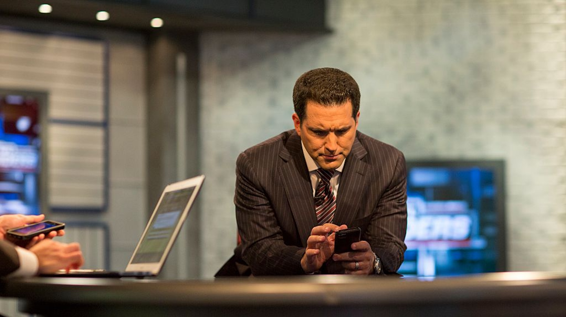 Adam Schefter looking at his phone