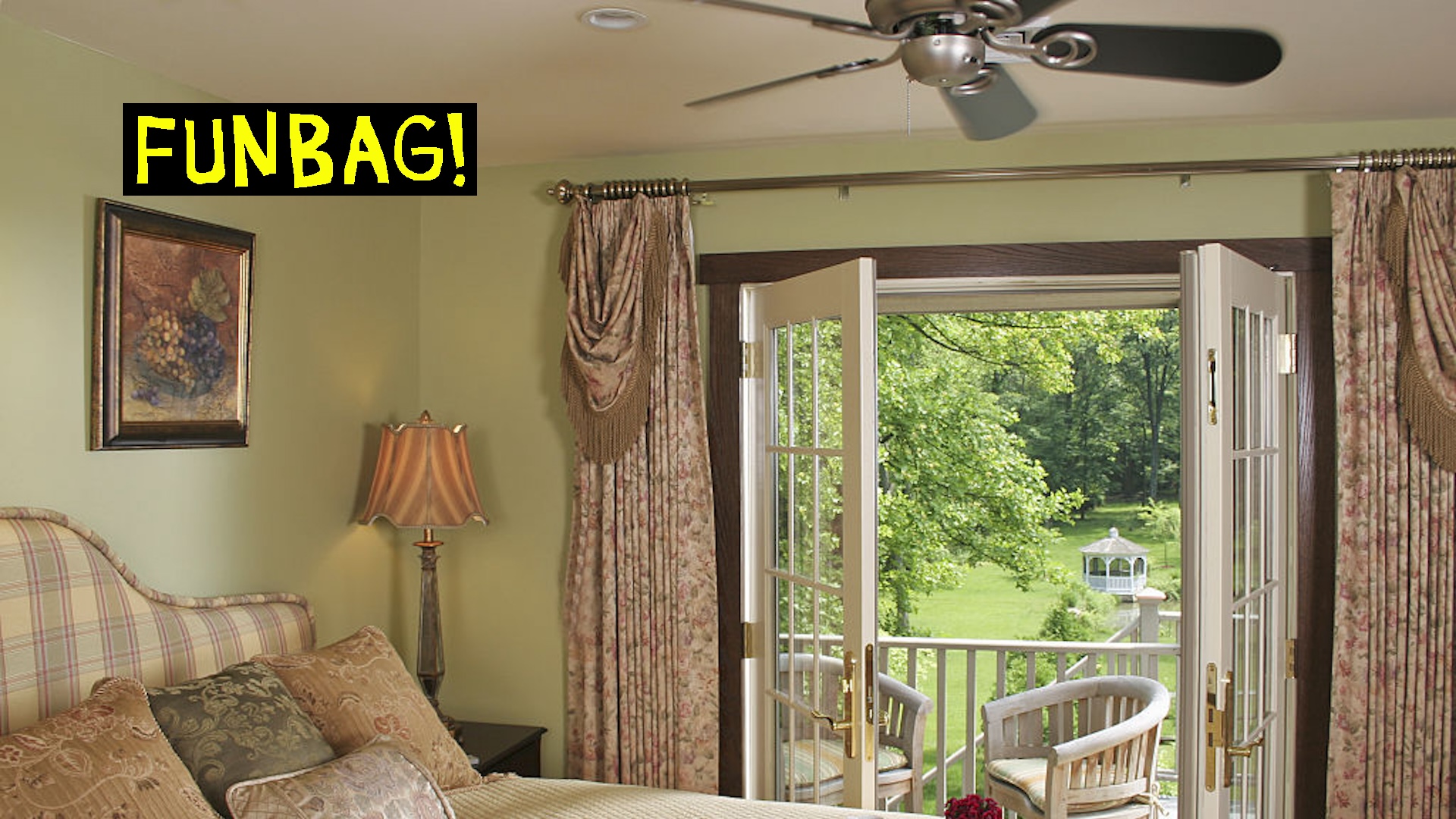 Breakfast tray on double bed next to open French doors.