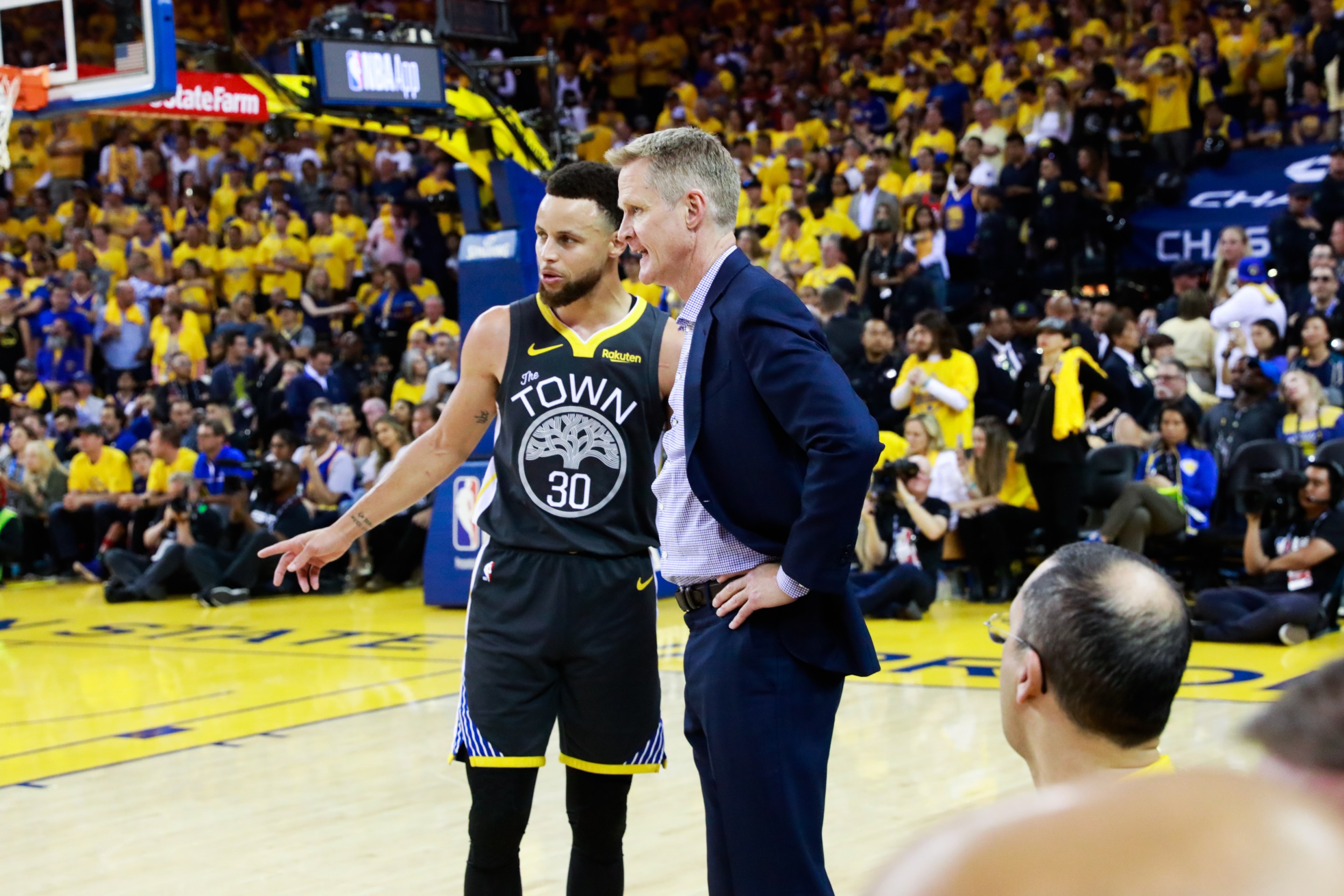 Stephen Curry (30) speaks with coach Steve Kerr during the first half of Game 6 of the NBA Finals between the Golden State Warriors and the Toronto Raptors in Oakland, California, on Thursday, June 13, 2019.
