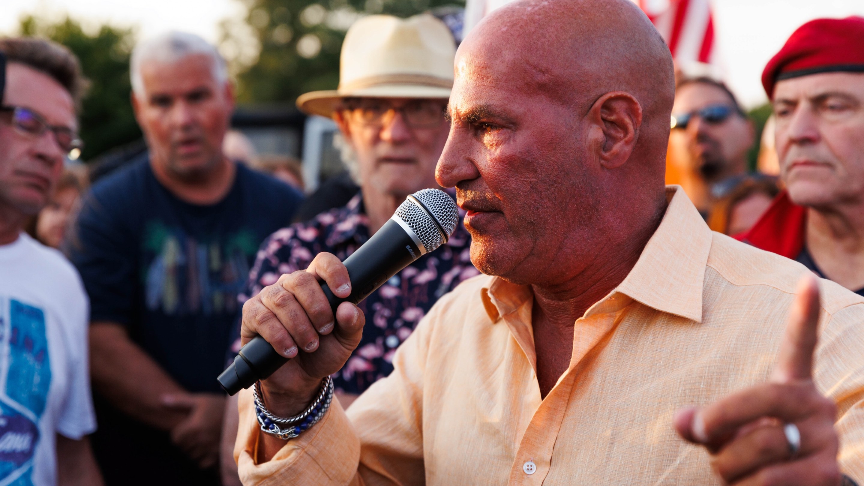 WABC radio host Sid Rosenberg speaks during a protest against a tent shelter for migrants at Floyd Bennett Field in the Brooklyn borough of New York City on August 22, 2023. They're rallying against immigrants being housed there so everyone in the picture looks like someone who'd do that.