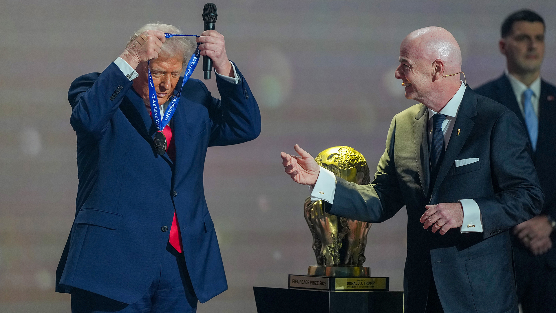 U.S. President Donald Trump receives the FIFA Peace Prize from Gianni Infantino, President of FIFA, during the FIFA World Cup 2026 Official Draw at John F. Kennedy Center for the Performing Arts on December 05, 2025 in Washington, DC.