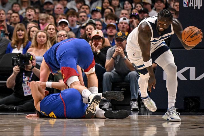 Nikola Jokic (15) of the Denver Nuggets falls over Julian Strawther (3) as Julius Randle (30) of the Minnesota Timberwolves runs in transition