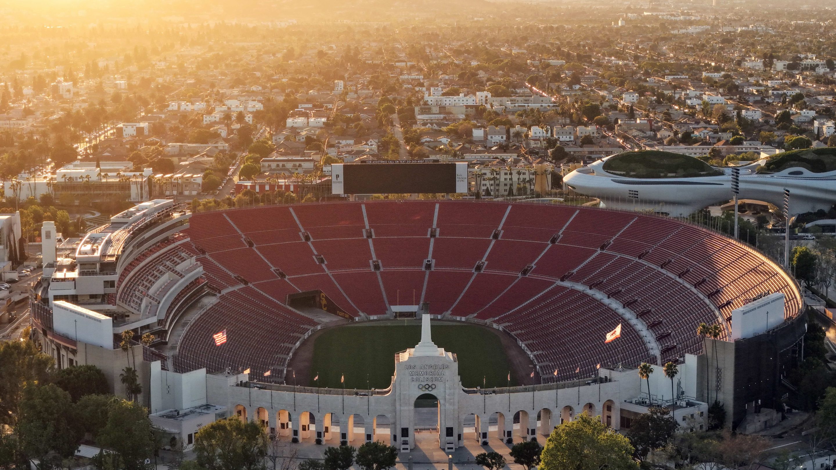 In an aerial view, Los Angeles Memorial Coliseum and the Lucas Museum of Narrative Art (R) are shown in Exposition Park on March 5, 2026 in Los Angeles, California.