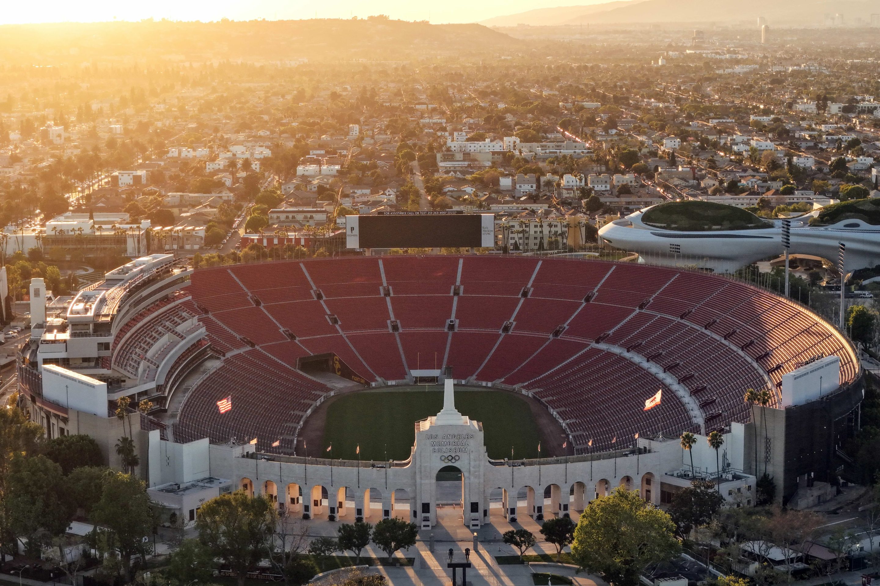 In an aerial view, Los Angeles Memorial Coliseum and the Lucas Museum of Narrative Art (R) are shown in Exposition Park on March 5, 2026 in Los Angeles, California.