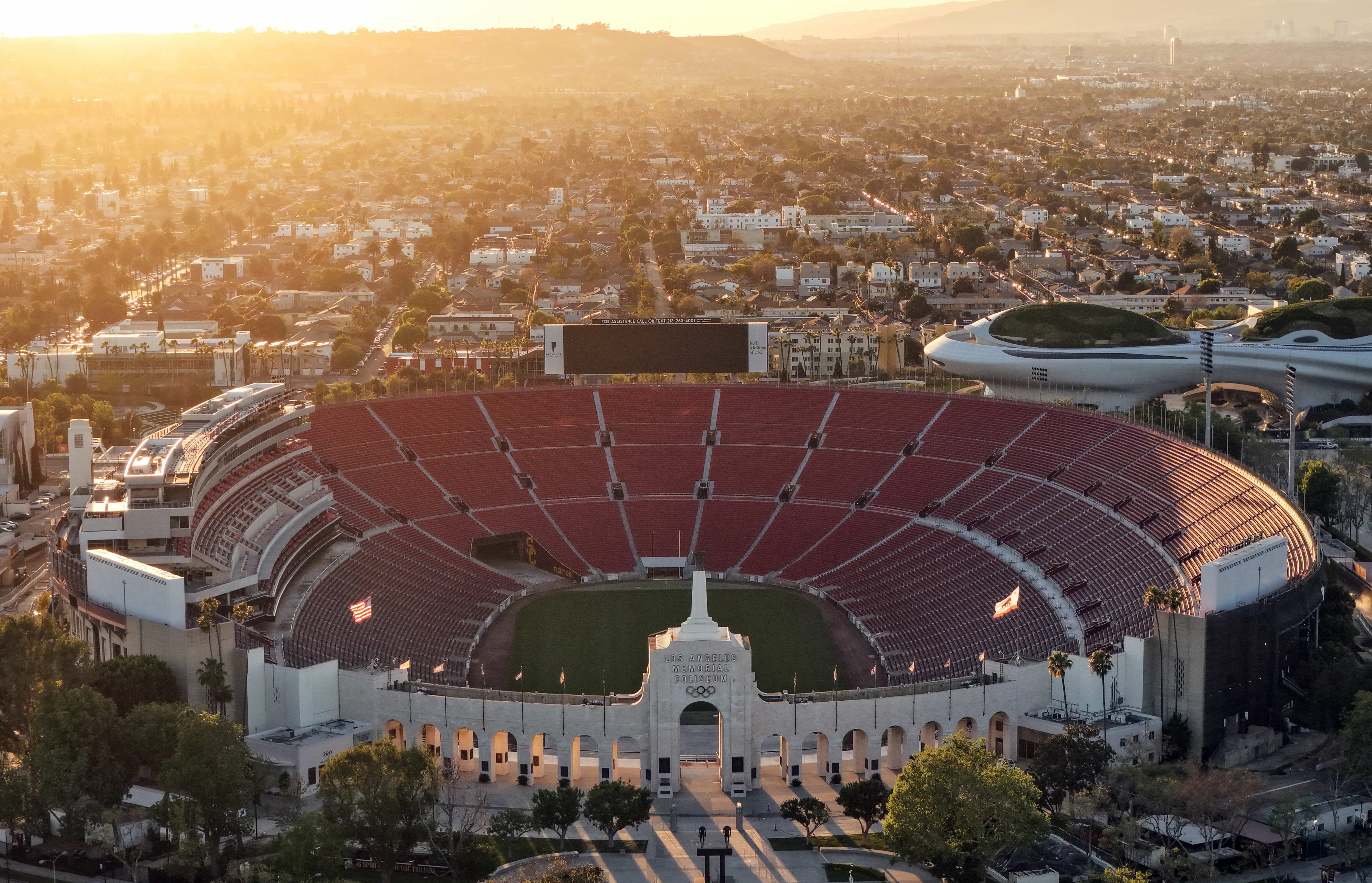 In an aerial view, Los Angeles Memorial Coliseum and the Lucas Museum of Narrative Art (R) are shown in Exposition Park on March 5, 2026 in Los Angeles, California.
