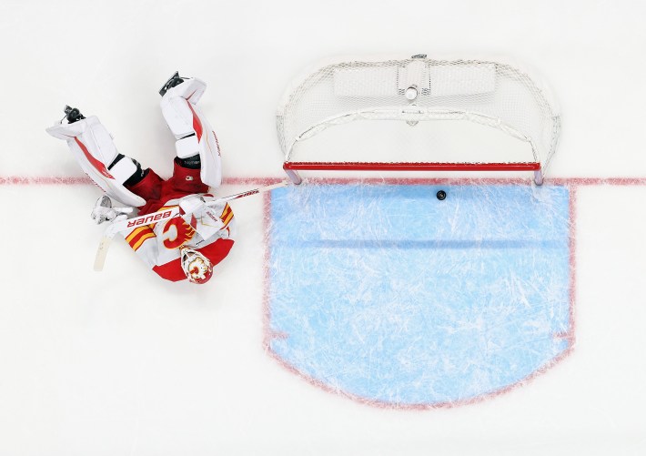 Devin Cooley #1 of the Calgary Flames reacts to a first period goal by Simon Holmstrom #92 of the New York Islanders