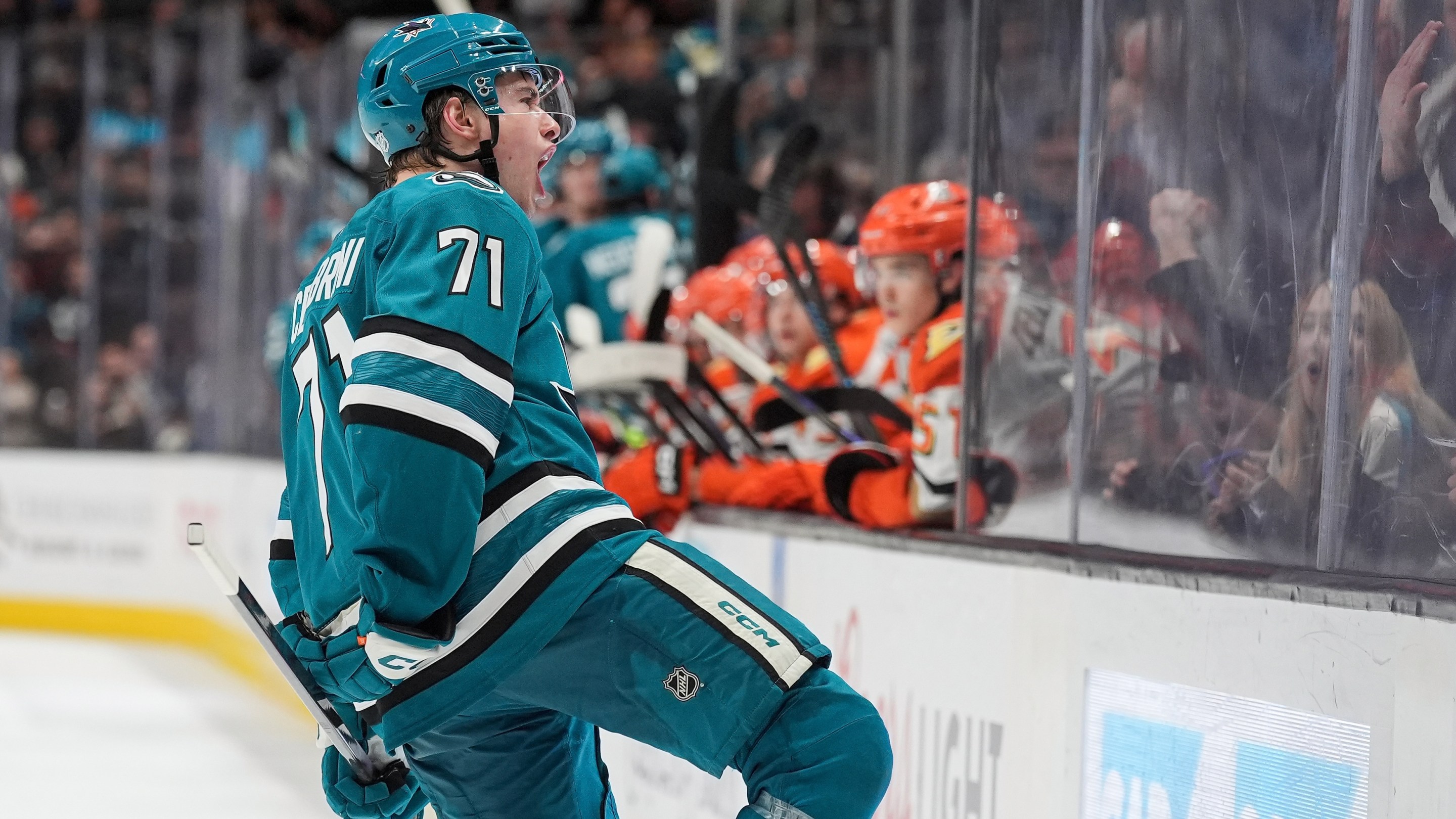 Macklin Celebrini of the San Jose Sharks celebrates scoring a goal in the third period against the Anaheim Ducks at SAP Center on April 1, 2026 in San Jose, California. You can see the Ducks guys looking upset in the background.