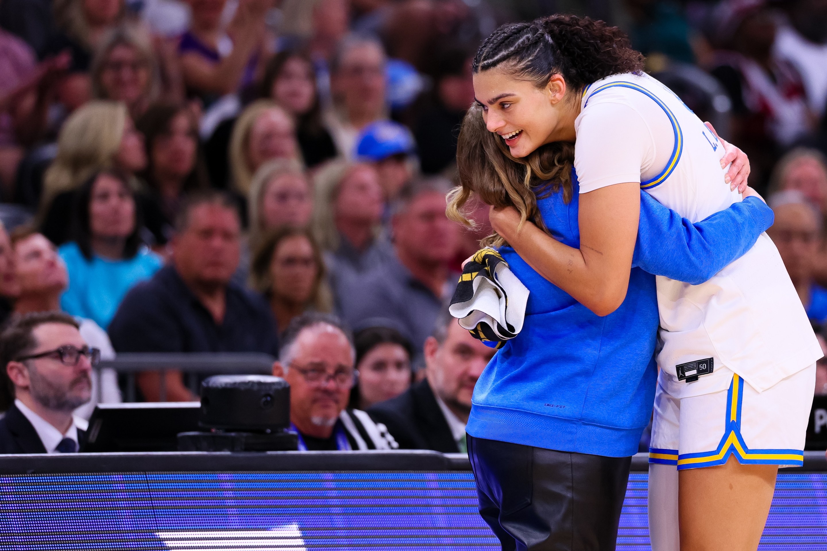 Lauren Betts #51 hugs Head coach Cori Close of the UCLA Bruins during the second half of the NCAA Women's Basketball Championship game against the South Carolina Gamecocks at Mortgage Matchup Center on April 5, 2026 in Phoenix, Arizona.