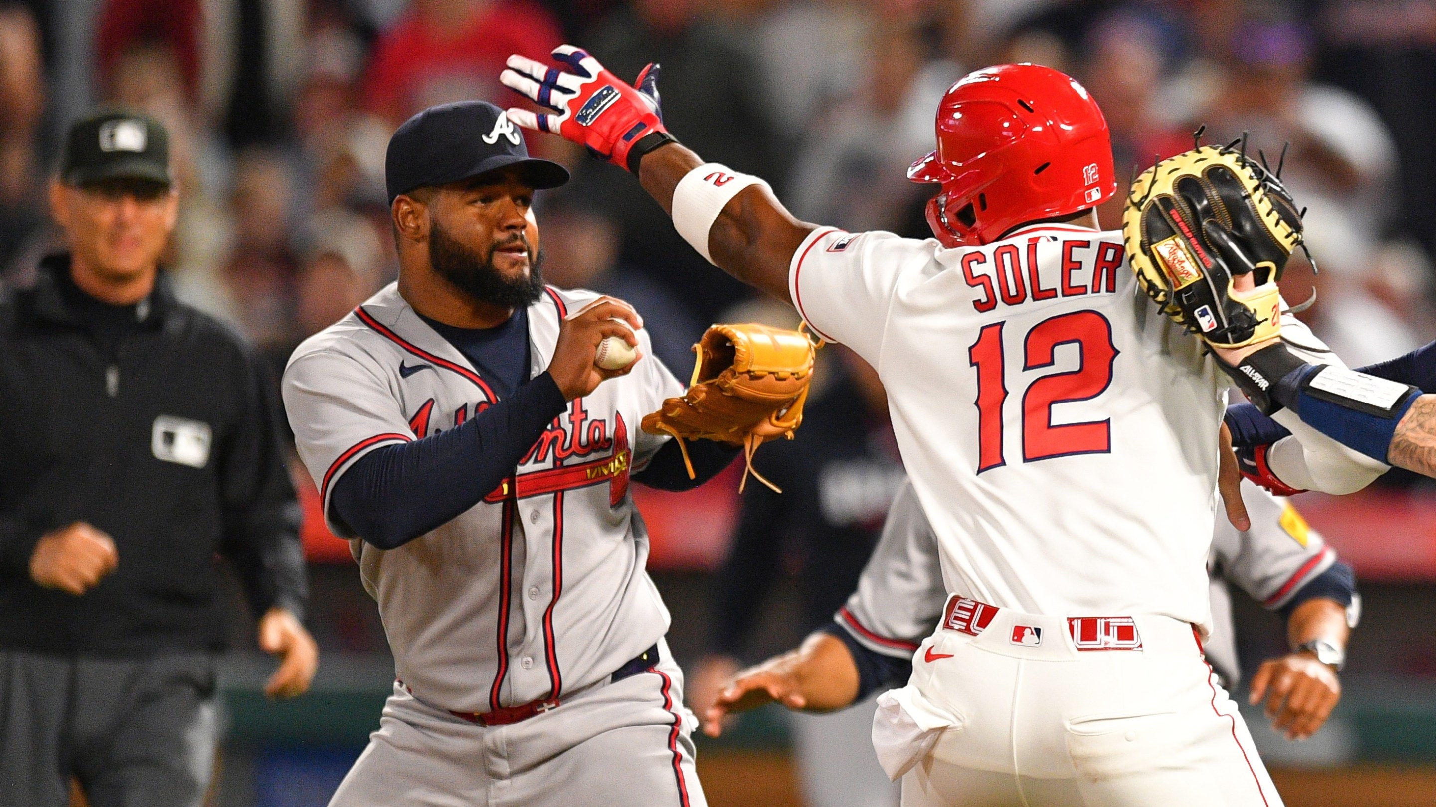 ANAHEIM, CA - APRIL 07: Atlanta Braves catcher Jonah Heim (20) tries to hold back Los Angeles Angels designated hitter Jorge Soler (12) as he swings a punch at Atlanta Braves pitcher Reynaldo Lopez (40) on the mound as home plate umpire Edwin Moscoso trails the play during the MLB game between the Atlanta Braves and the Los Angeles Angels on April 7, 2026 at Angel Stadium in Anaheim, CA. (Photo by Brian Rothmuller/Icon Sportswire)