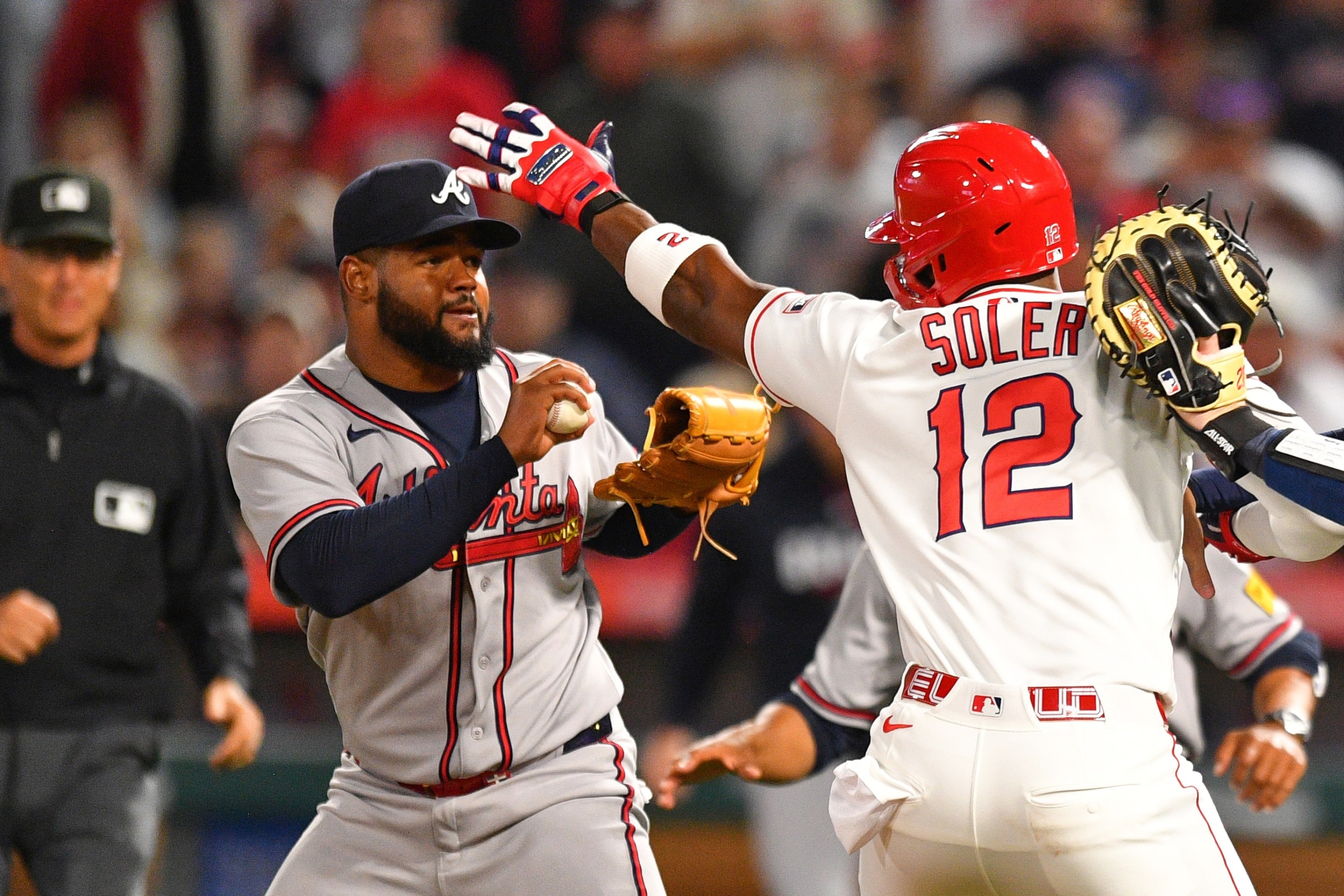 ANAHEIM, CA - APRIL 07: Atlanta Braves catcher Jonah Heim (20) tries to hold back Los Angeles Angels designated hitter Jorge Soler (12) as he swings a punch at Atlanta Braves pitcher Reynaldo Lopez (40) on the mound as home plate umpire Edwin Moscoso trails the play during the MLB game between the Atlanta Braves and the Los Angeles Angels on April 7, 2026 at Angel Stadium in Anaheim, CA. (Photo by Brian Rothmuller/Icon Sportswire)