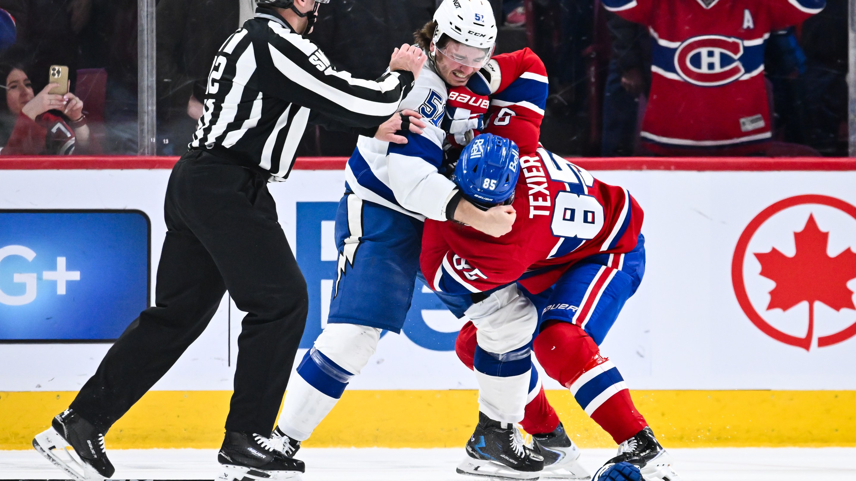Charle-Edouard D'Astous #51 of the Tampa Bay Lightning and Alexandre Texier #85 of the Montréal Canadiens fight during the second period at the Bell Centre