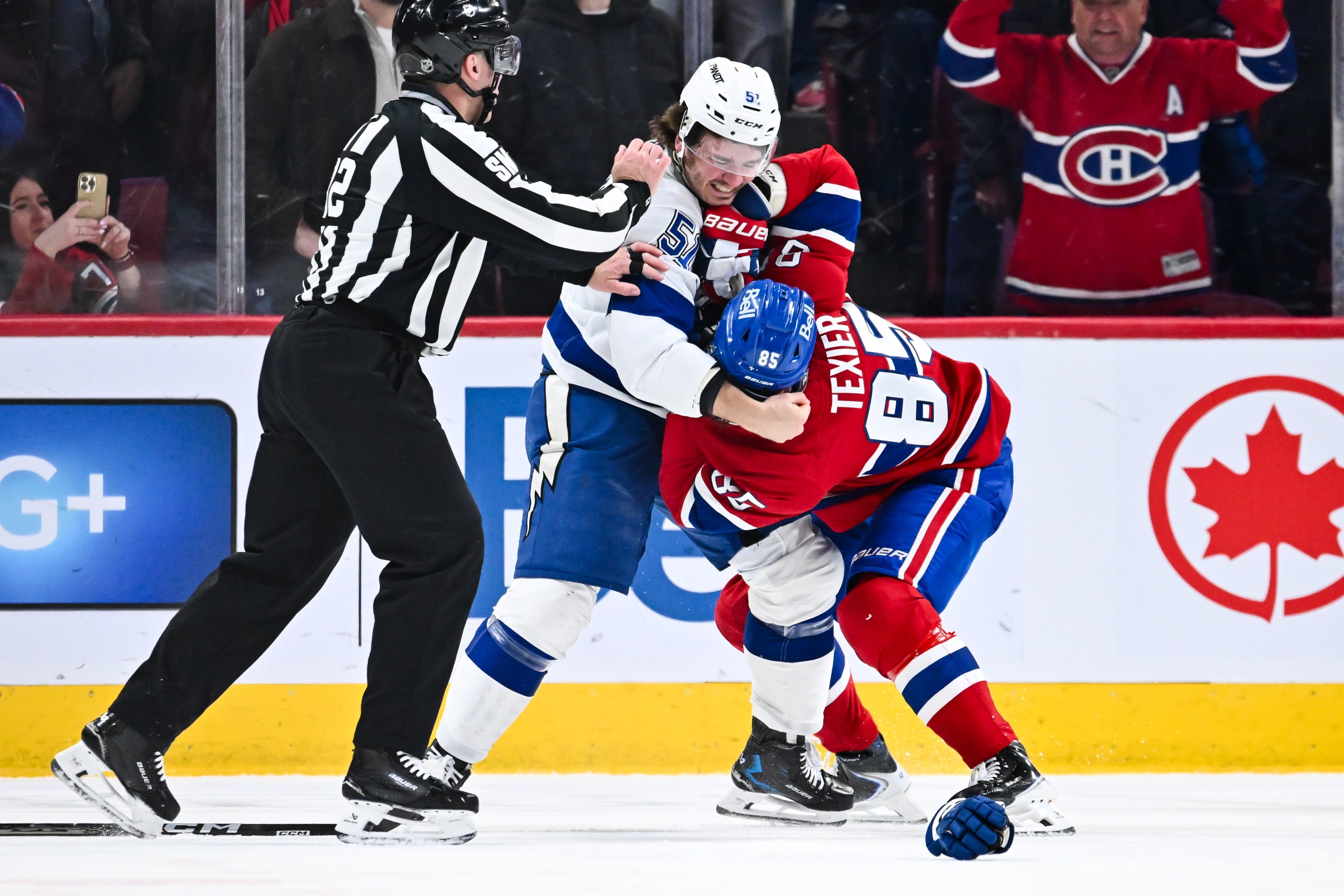 Charle-Edouard D'Astous #51 of the Tampa Bay Lightning and Alexandre Texier #85 of the Montréal Canadiens fight during the second period at the Bell Centre