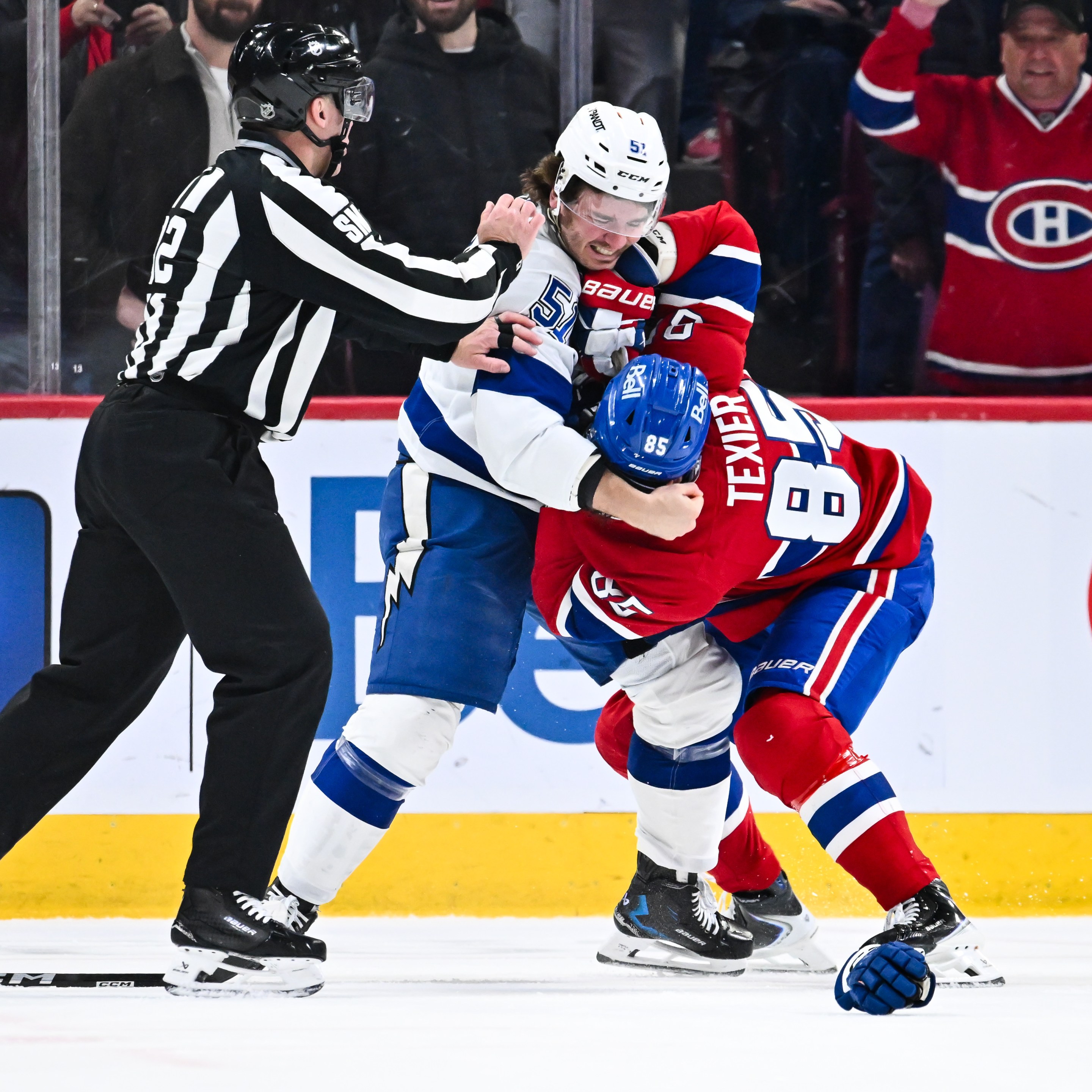 Charle-Edouard D'Astous #51 of the Tampa Bay Lightning and Alexandre Texier #85 of the Montréal Canadiens fight during the second period at the Bell Centre
