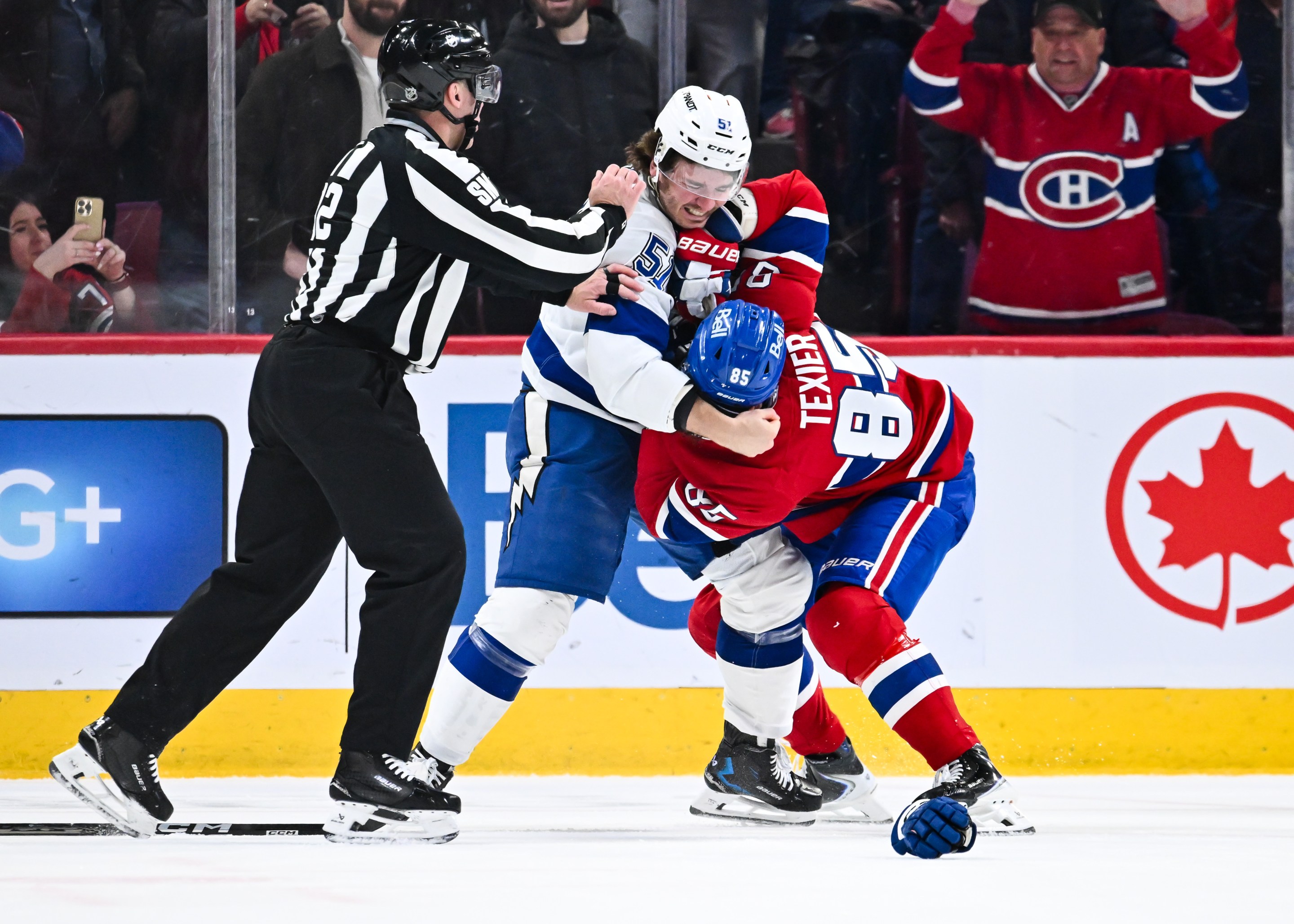Charle-Edouard D'Astous #51 of the Tampa Bay Lightning and Alexandre Texier #85 of the Montréal Canadiens fight during the second period at the Bell Centre