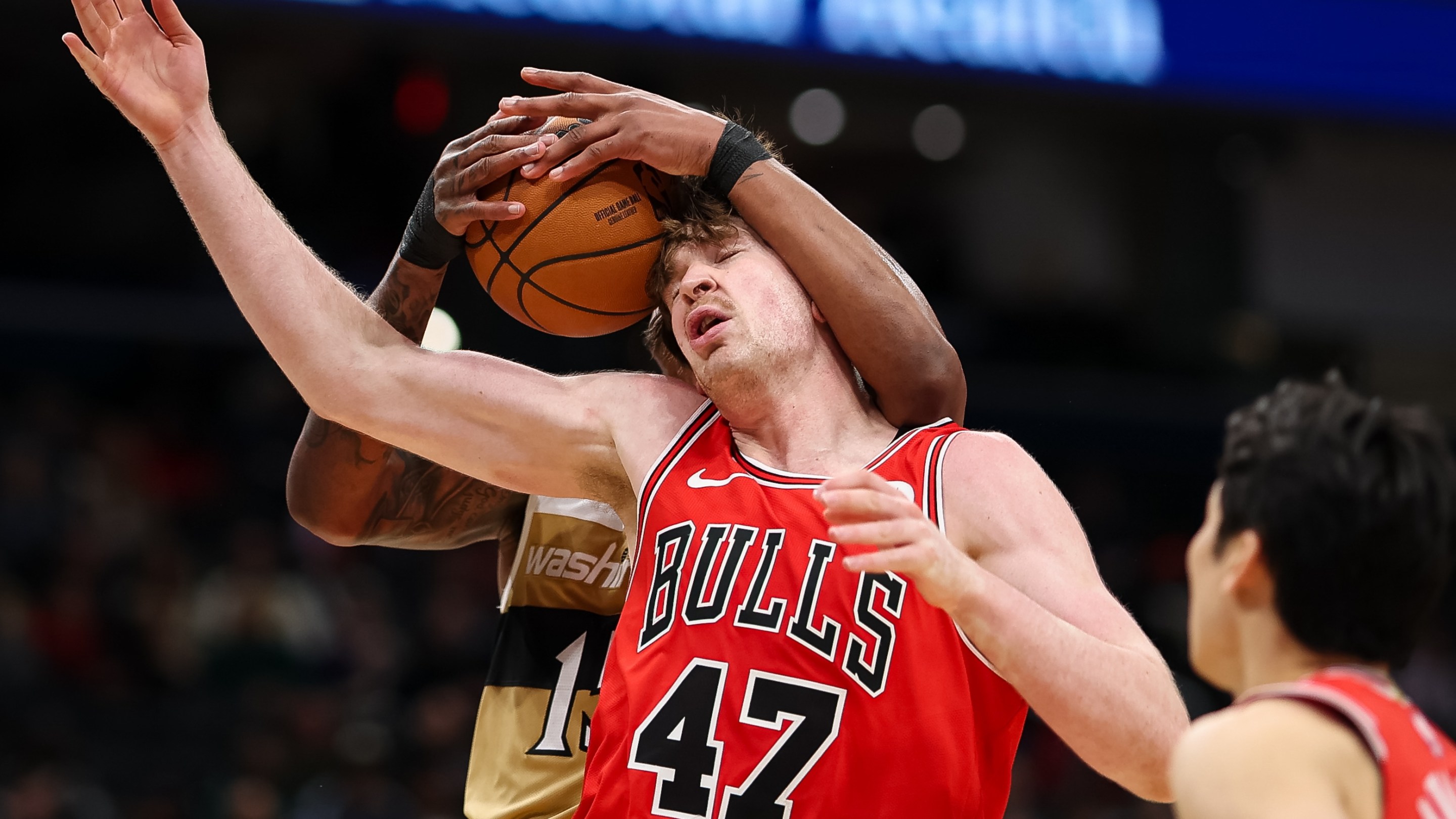 Julian Reese of the Washington Wizards and Lachlan Olbrich #47 of the Chicago Bulls fight for the ball during the second half at Capital One Arena on April 9, 2026 in Washington, DC.