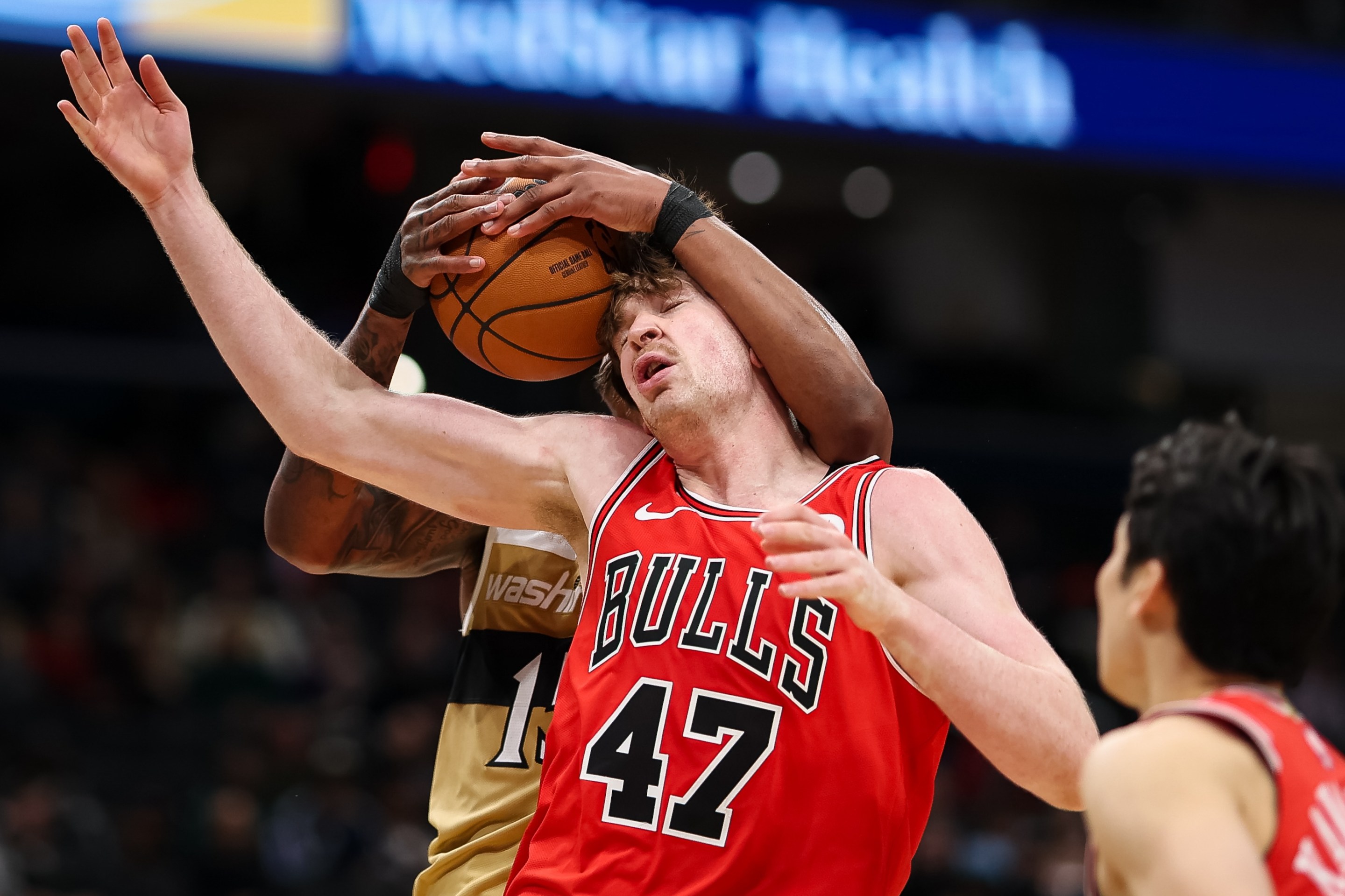 Julian Reese of the Washington Wizards and Lachlan Olbrich #47 of the Chicago Bulls fight for the ball during the second half at Capital One Arena on April 9, 2026 in Washington, DC.