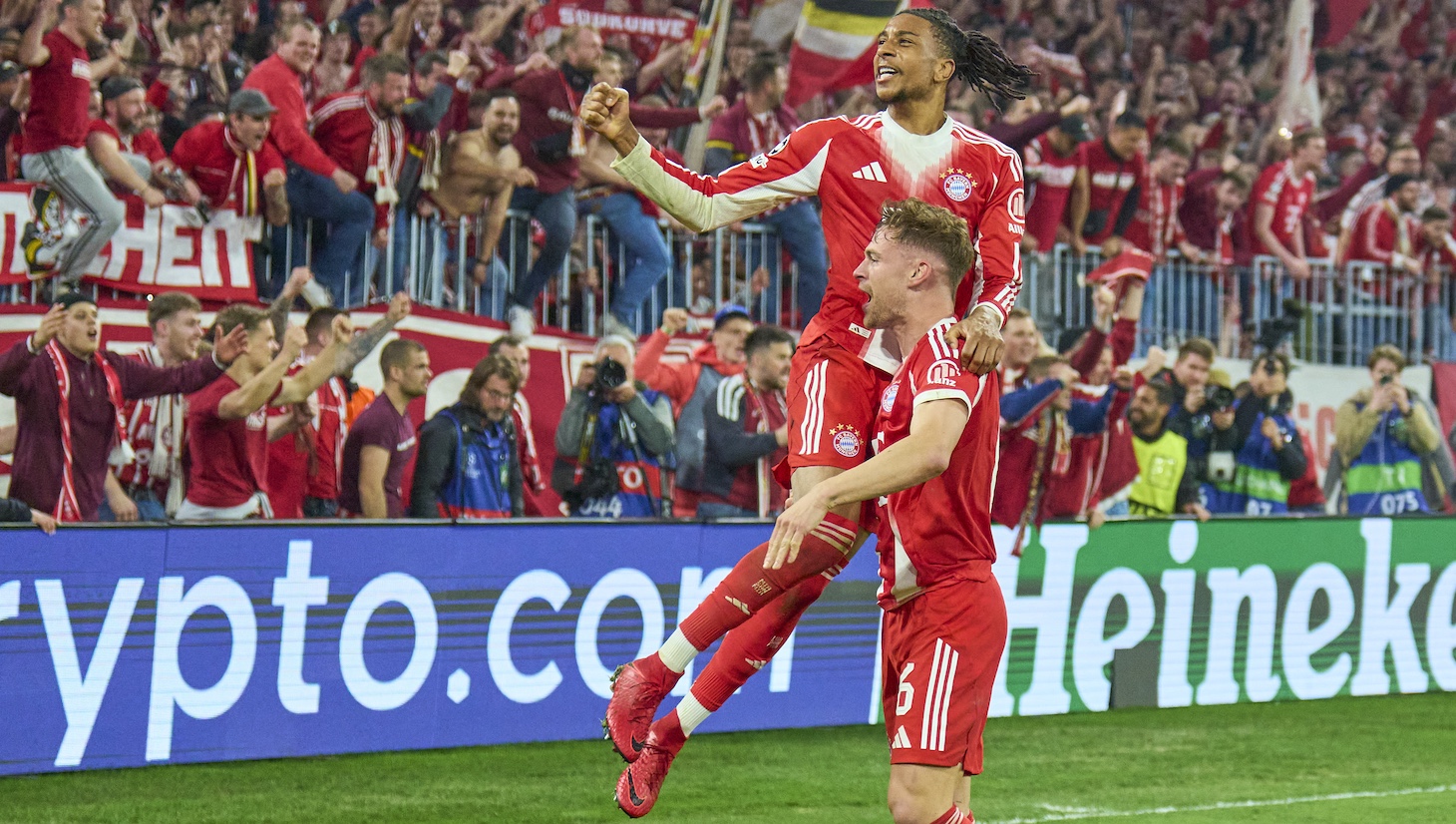 Michael Olise of FC Bayern München celebrates his 4-3 goal with Joshua Kimmich of FC Bayern München and fans during the UEFA Champions League 2025/26 Quarter-Final Second Leg match between FC Bayern München and Real Madrid CF.