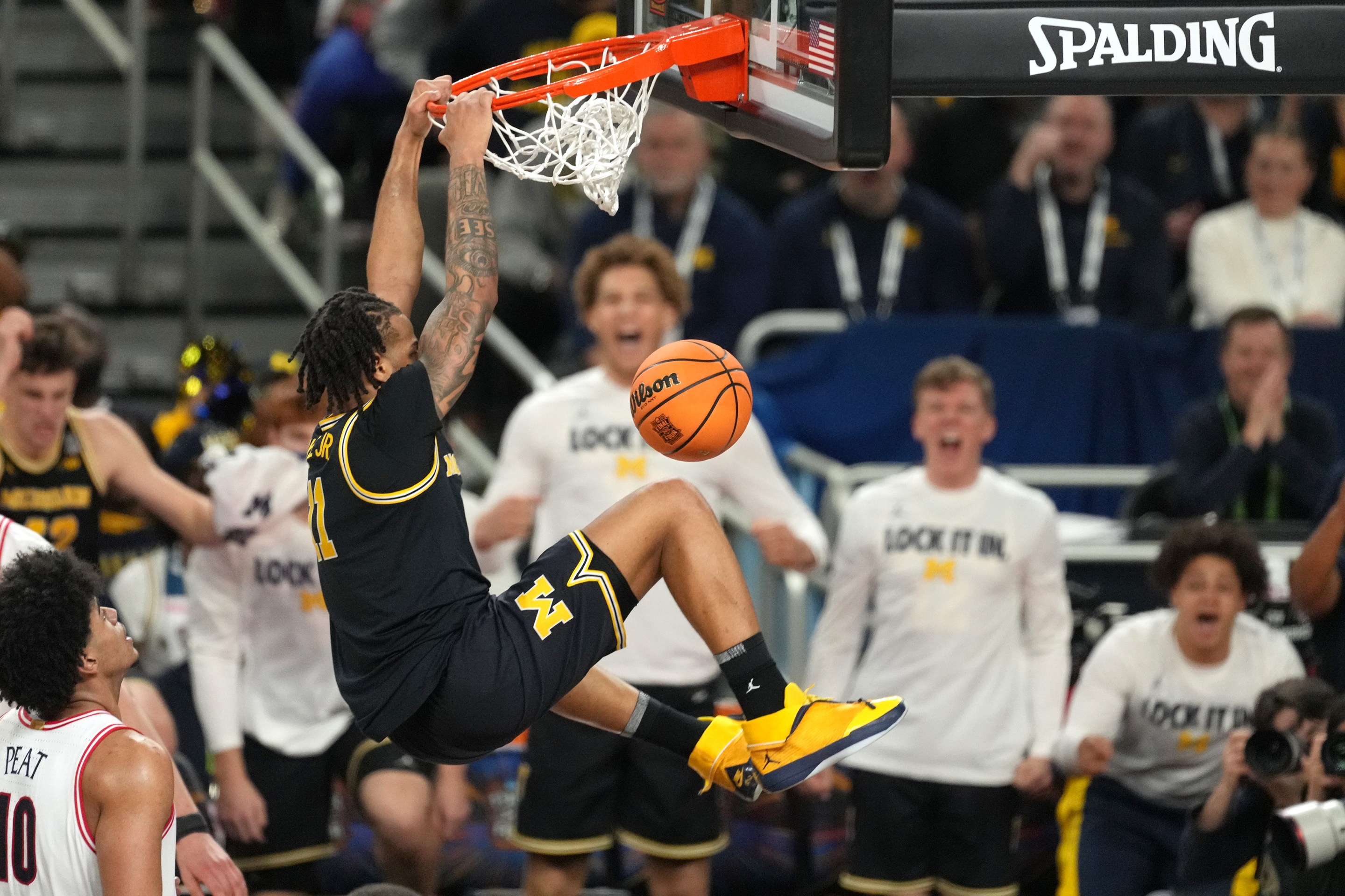 Morez Johnson Jr. of the Michigan Wolverines dunks the ball during the National Semifinal game of the 2026 NCAA Men's Basketball Tournament against the Arizona Wildcats at Lucas Oil Stadium on April 04, 2026.