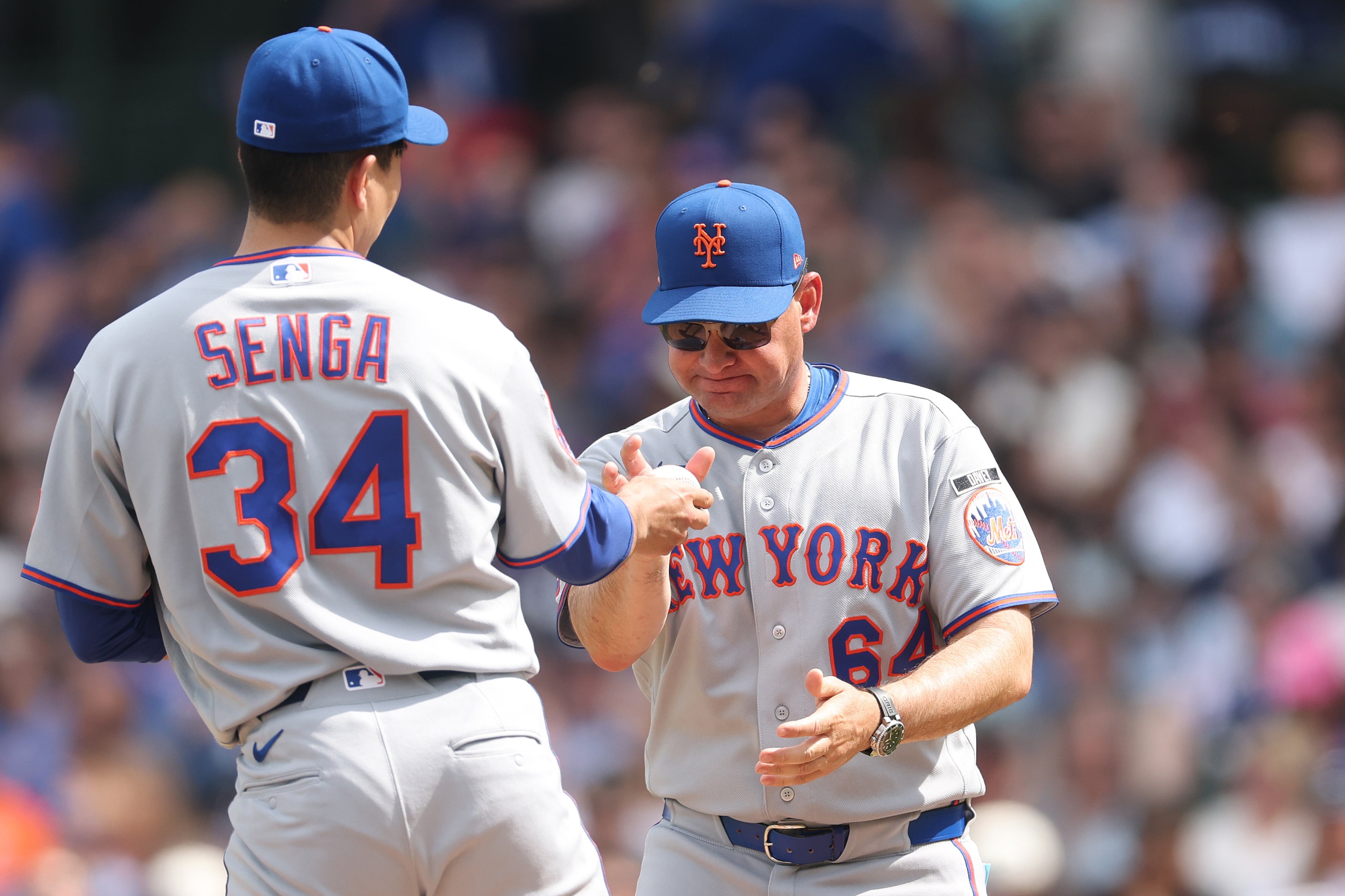 Manager Carlos Mendoza of the New York Mets removes Kodai Senga #34 from the game during the fourth inning against the Chicago Cubs at Wrigley Field on April 17, 2026 in Chicago, Illinois.