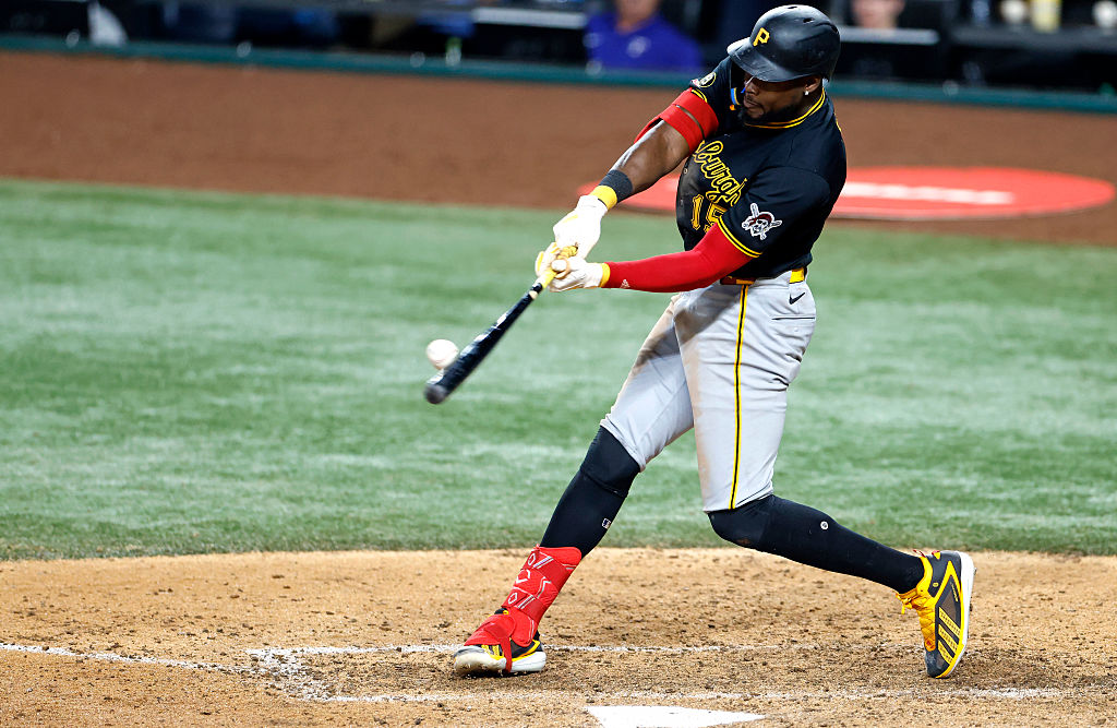 Oneil Cruz swings, the ball touching his bat on the sweet spot just in front of home plate.