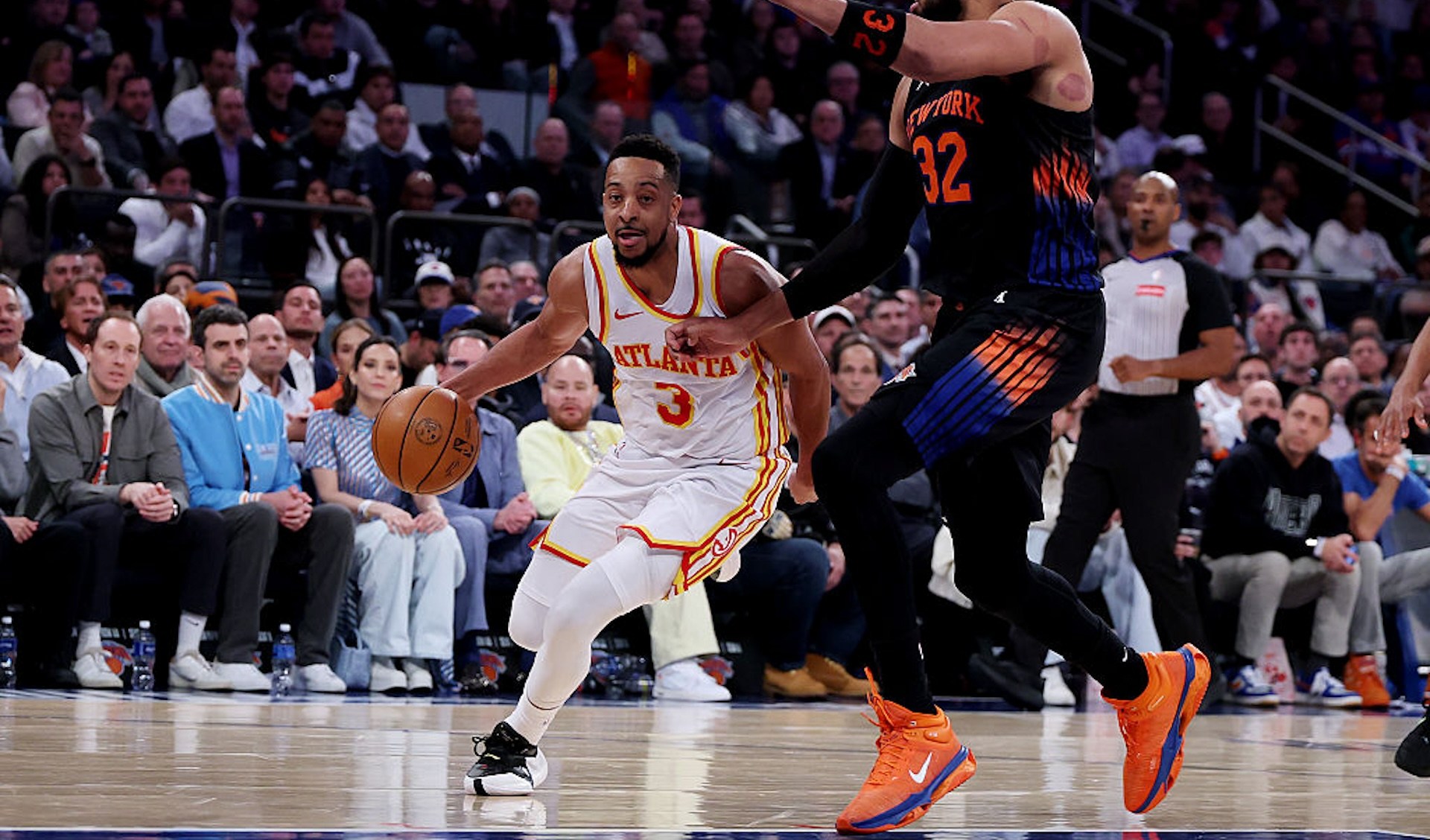CJ McCollum dribbles past Karl-Anthony Towns