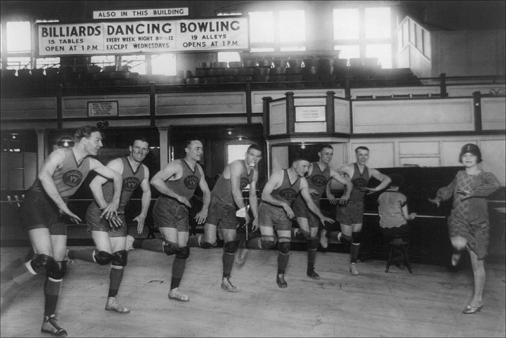 An old timey basketball team dancing